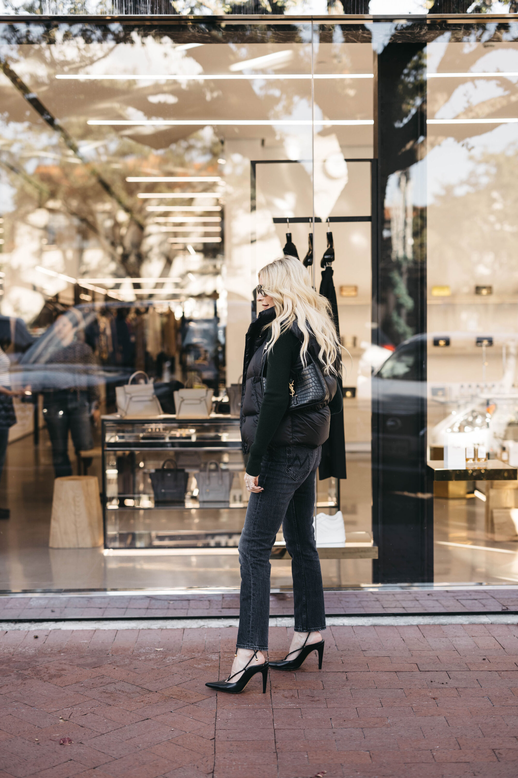 Over 40 fashion influencer wearing black Monochromatic look with lace up heels.