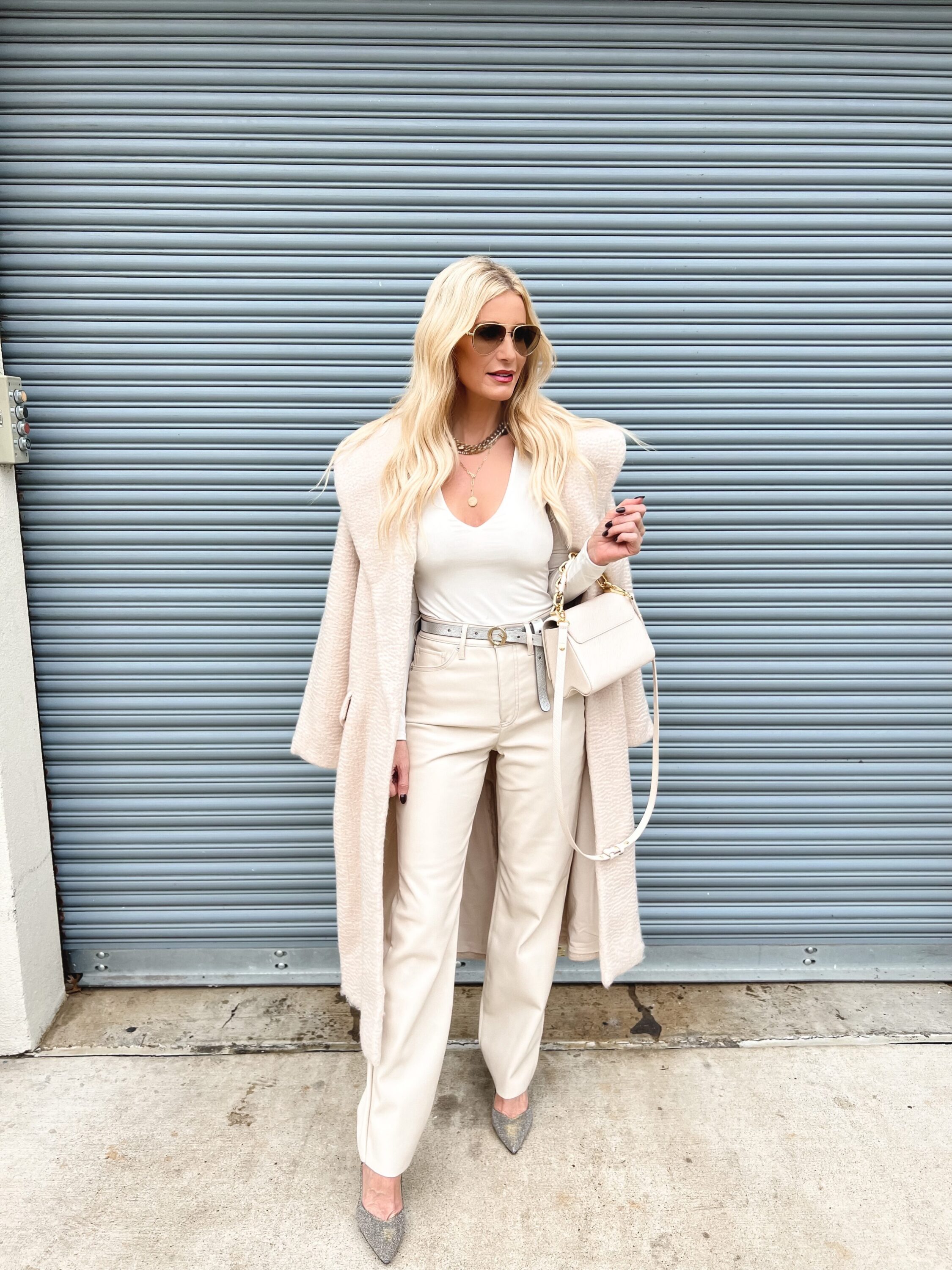 Over 40 Fashion icon wearing white bodysuit, ivory leather pants and a long ivory cardigan as one of 5 look for how to wear winter white.