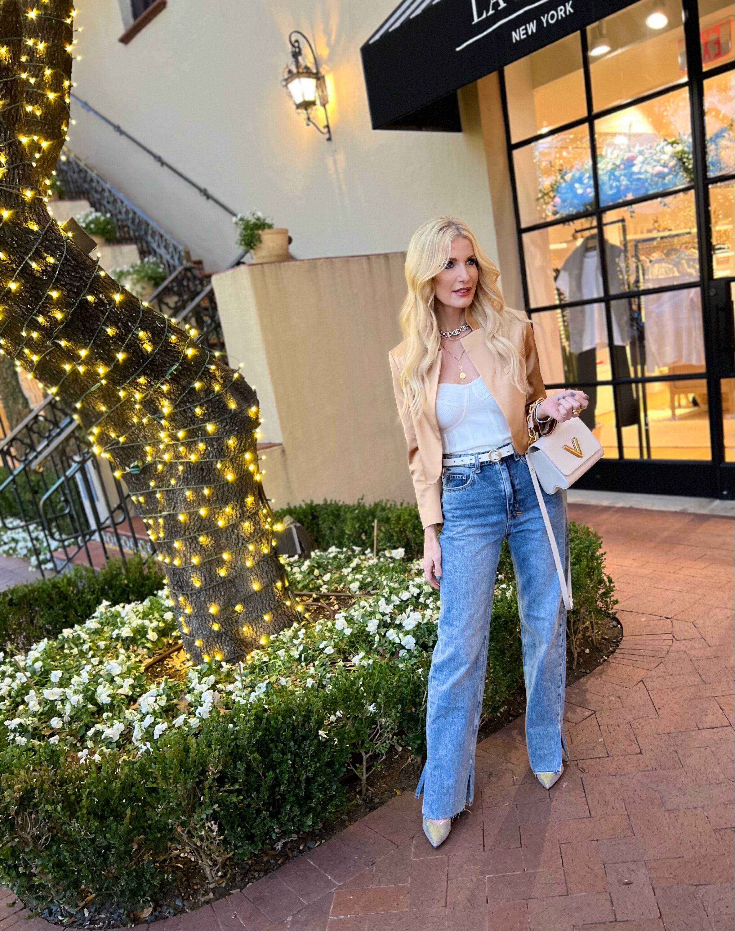 Over 40 fashion blogger wearing high-rise straight jeans with satin cropped blazer from Alice & Olivia.