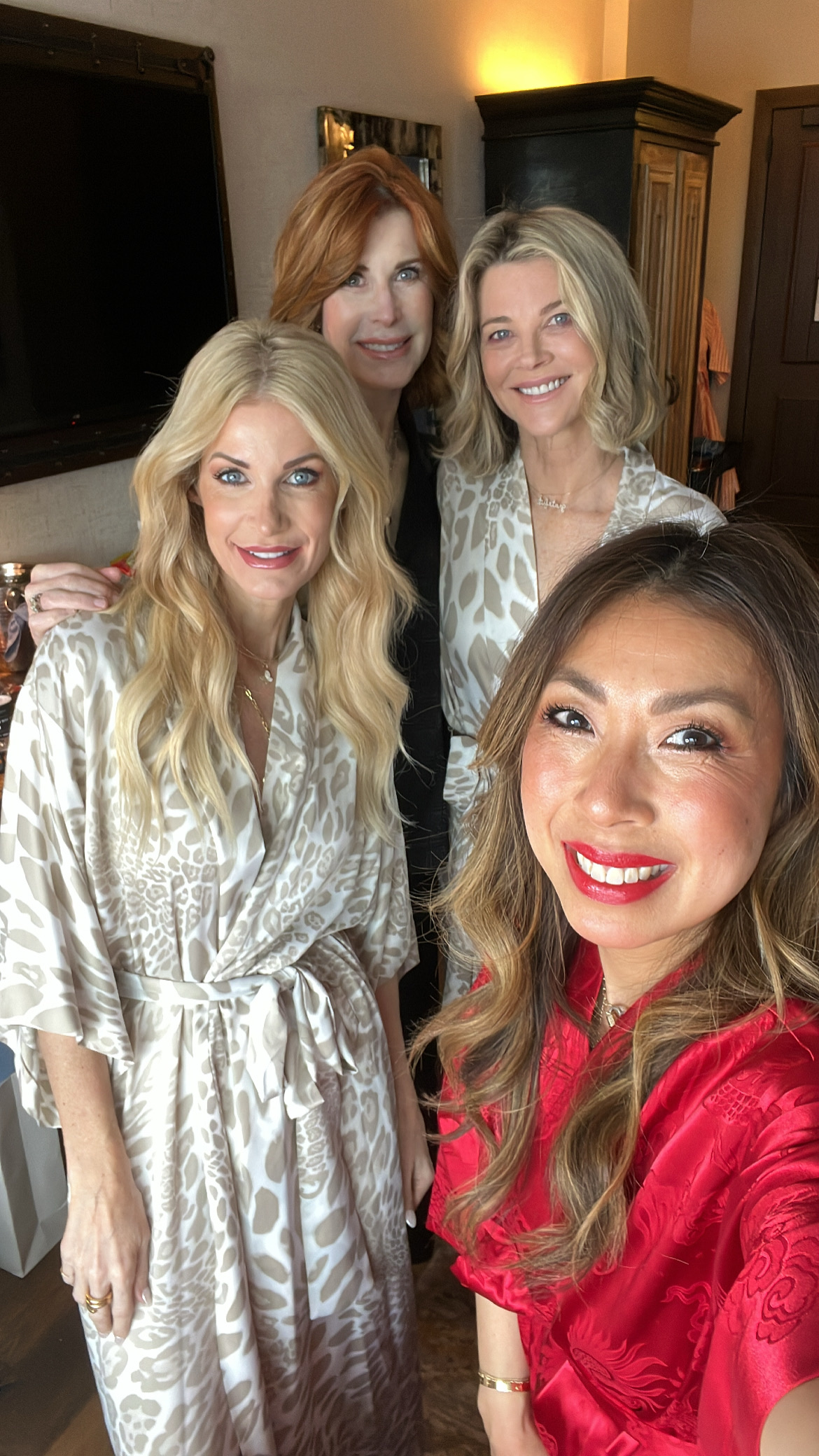 4 Dallas ladies over 40 having breakfast in bed at Hotel Drover wearing Natori robes and pajamas.