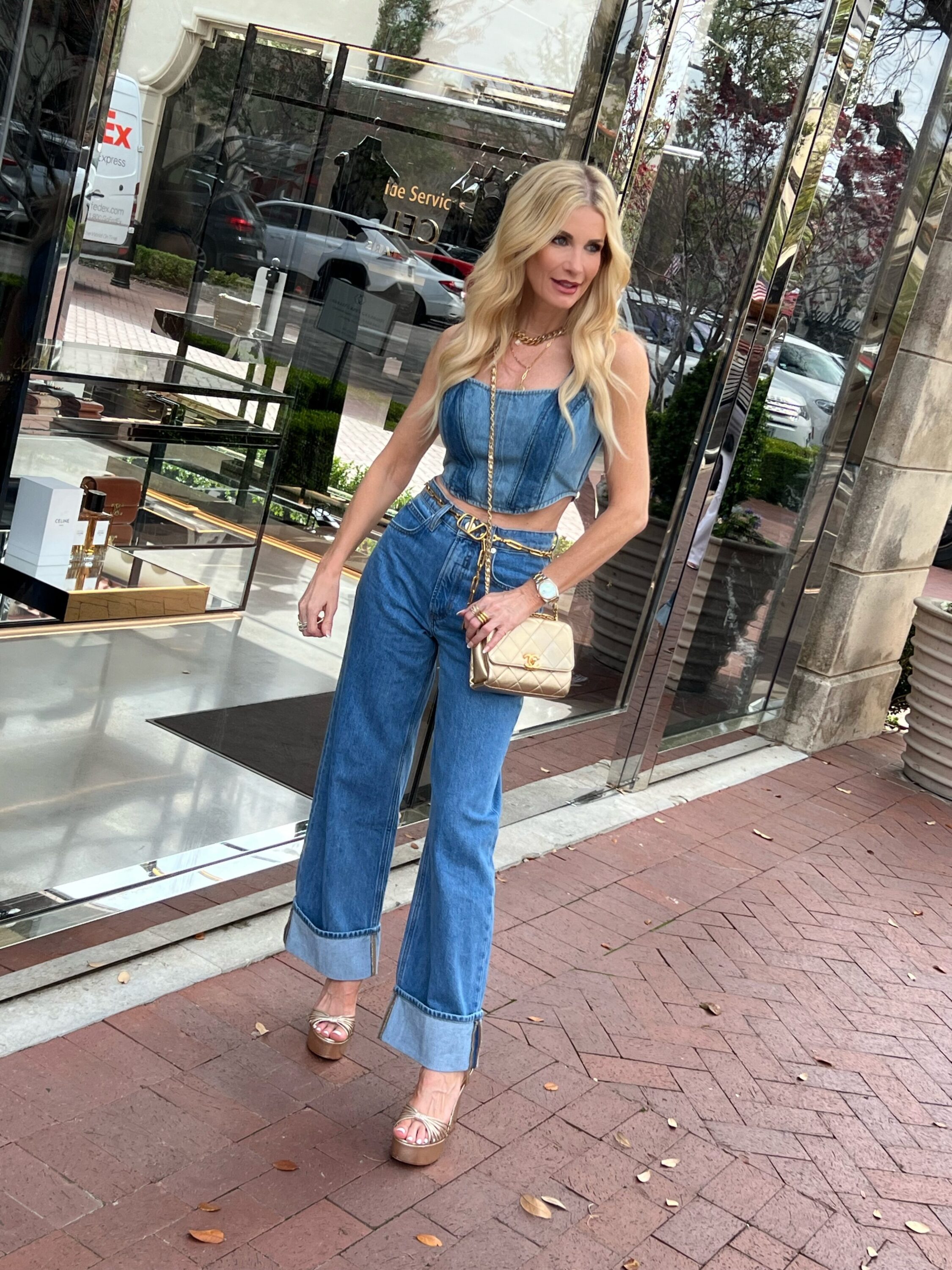 Dallas fashion blogger for the over 40 niche wearing wide-leg denim by Fram with a denim bustier top and gold accessories as one of the top spring denim trends of 2023.