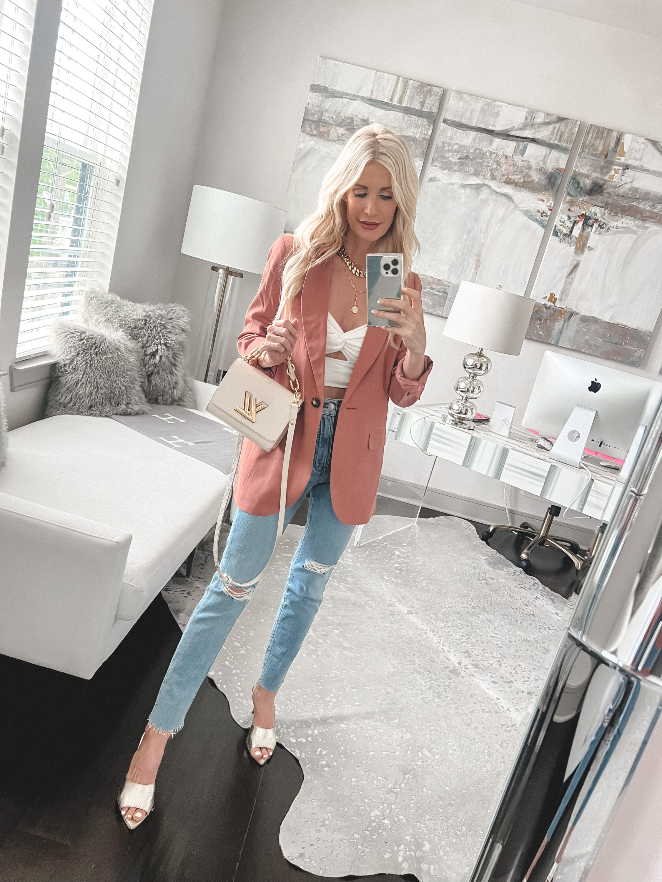 Over 40 Fashion stylist wearing a linen blazer with a white twist top and crop jeans as one of 5 summer jackets.