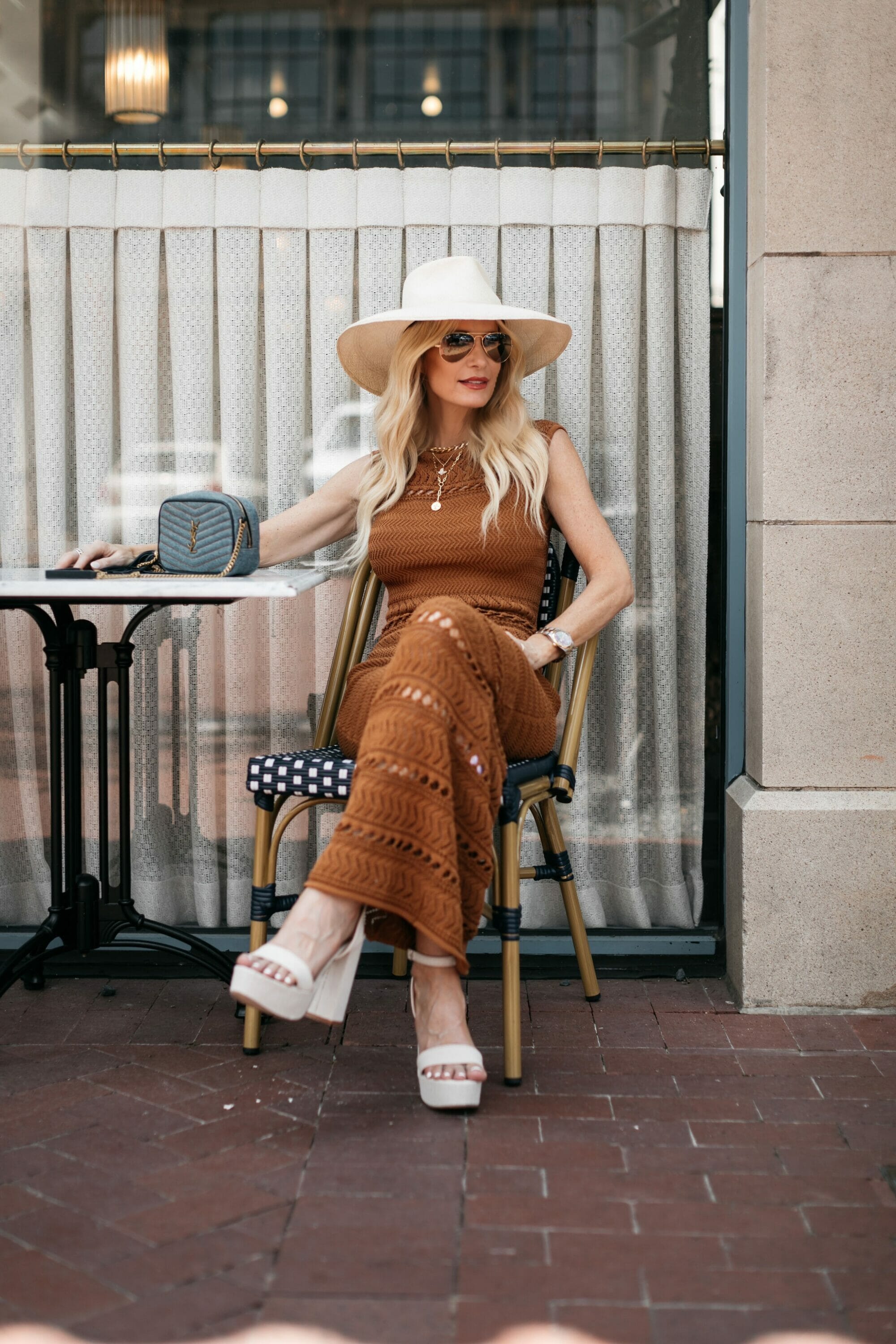 Dallas stylist for the over 40 age group wearing a set of stacked necklaces to elongate her neck as one example of how to look slimmer in a dress.
