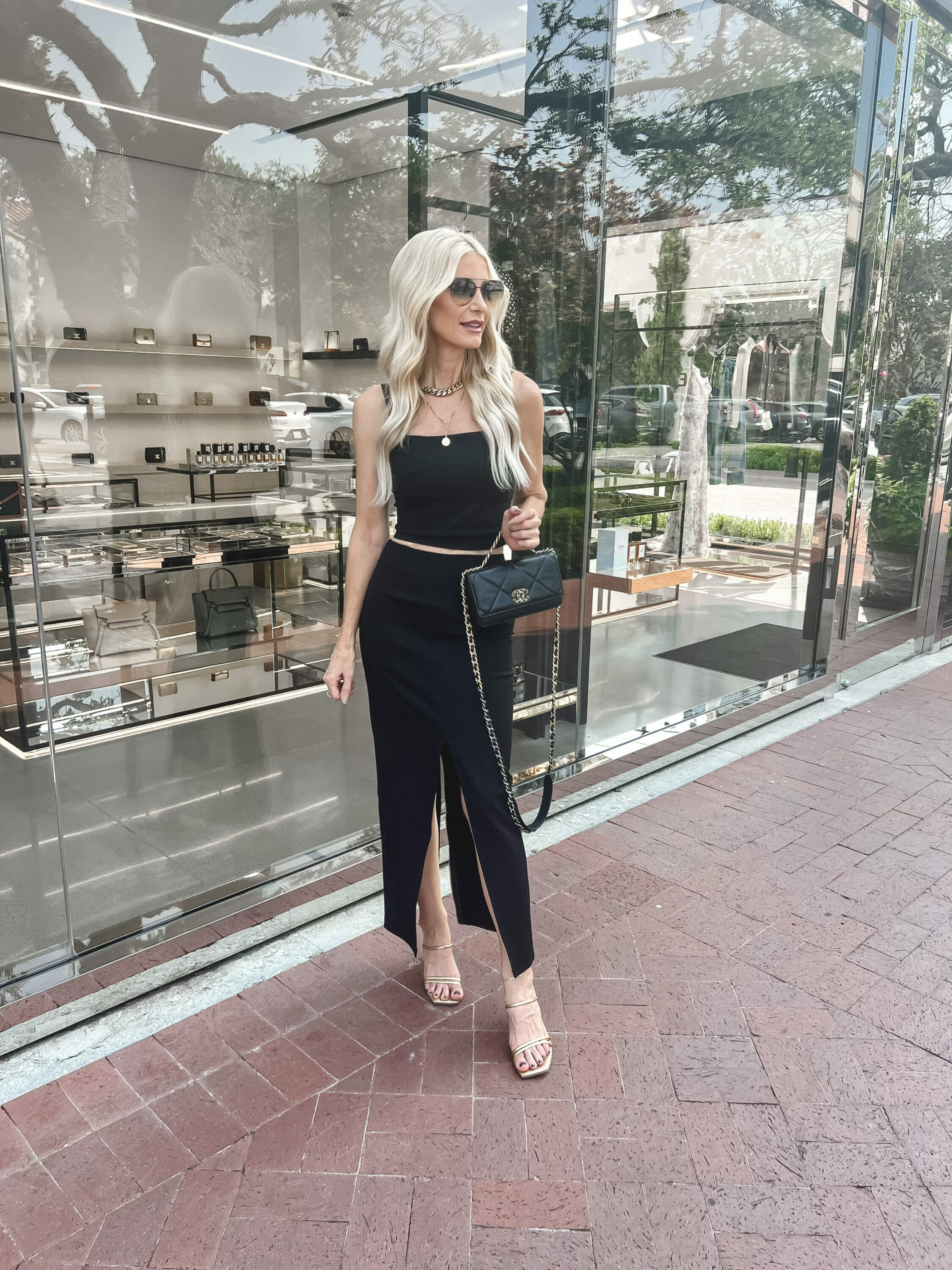 Dallas woman over 40 wearing a 2 piece set from Kare Millen with gold accessories.