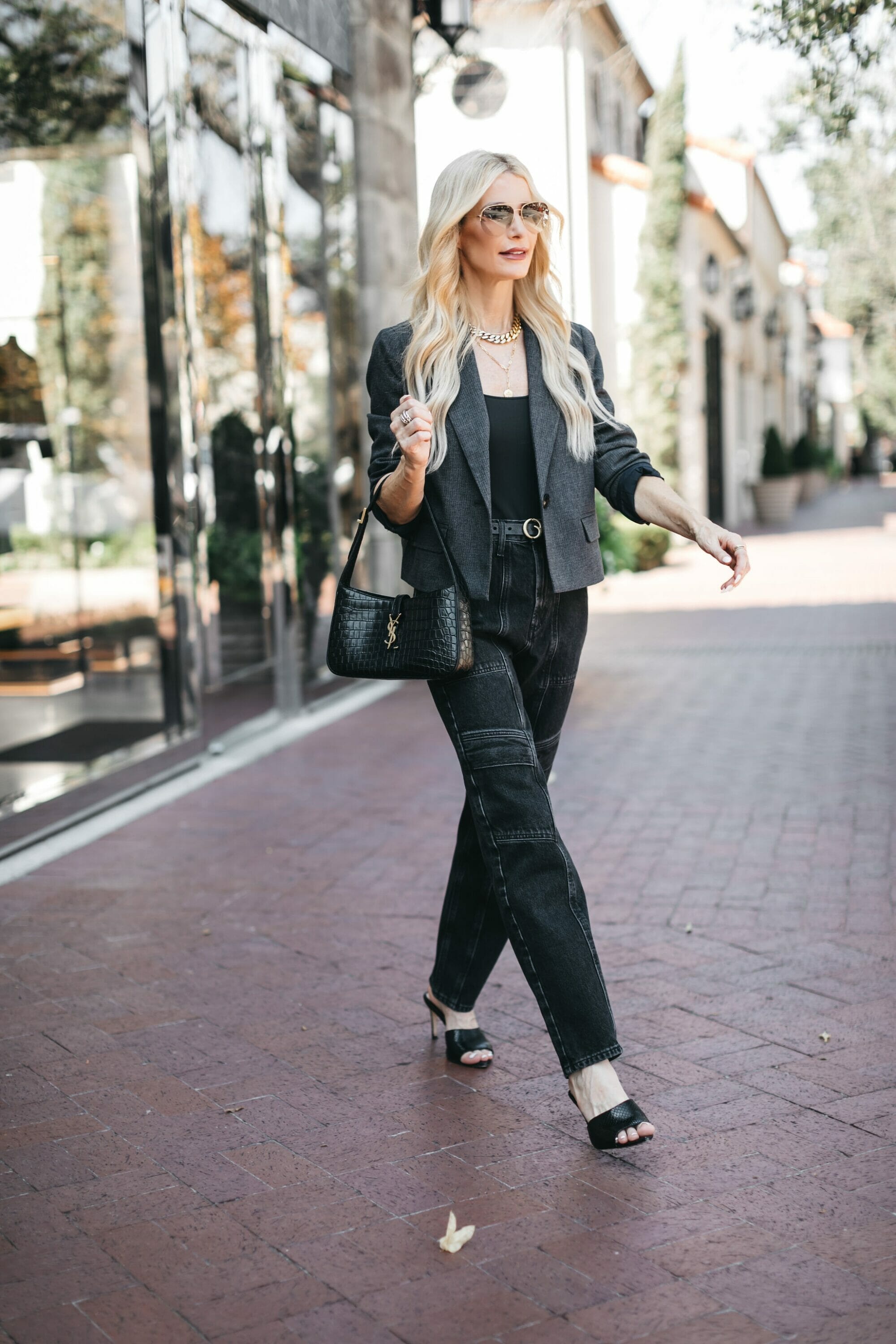 Dallas over 40 fashion influencer wearing black cargo pants with a cropped plaid jacket as one of the most wearable fall fashion trends.