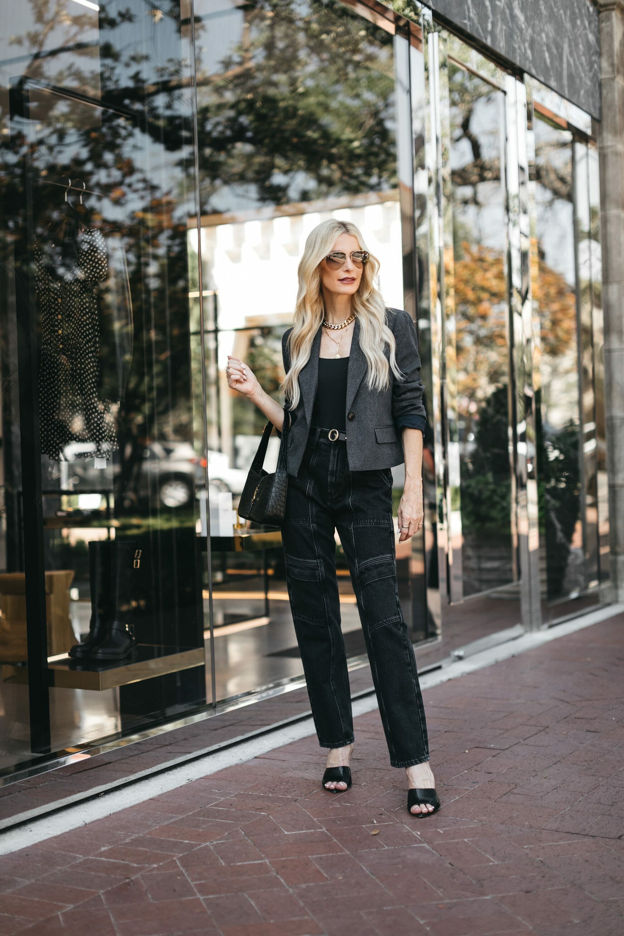 Over 40 fashion stylist wearing black cargo pants with grey plaid blazer.