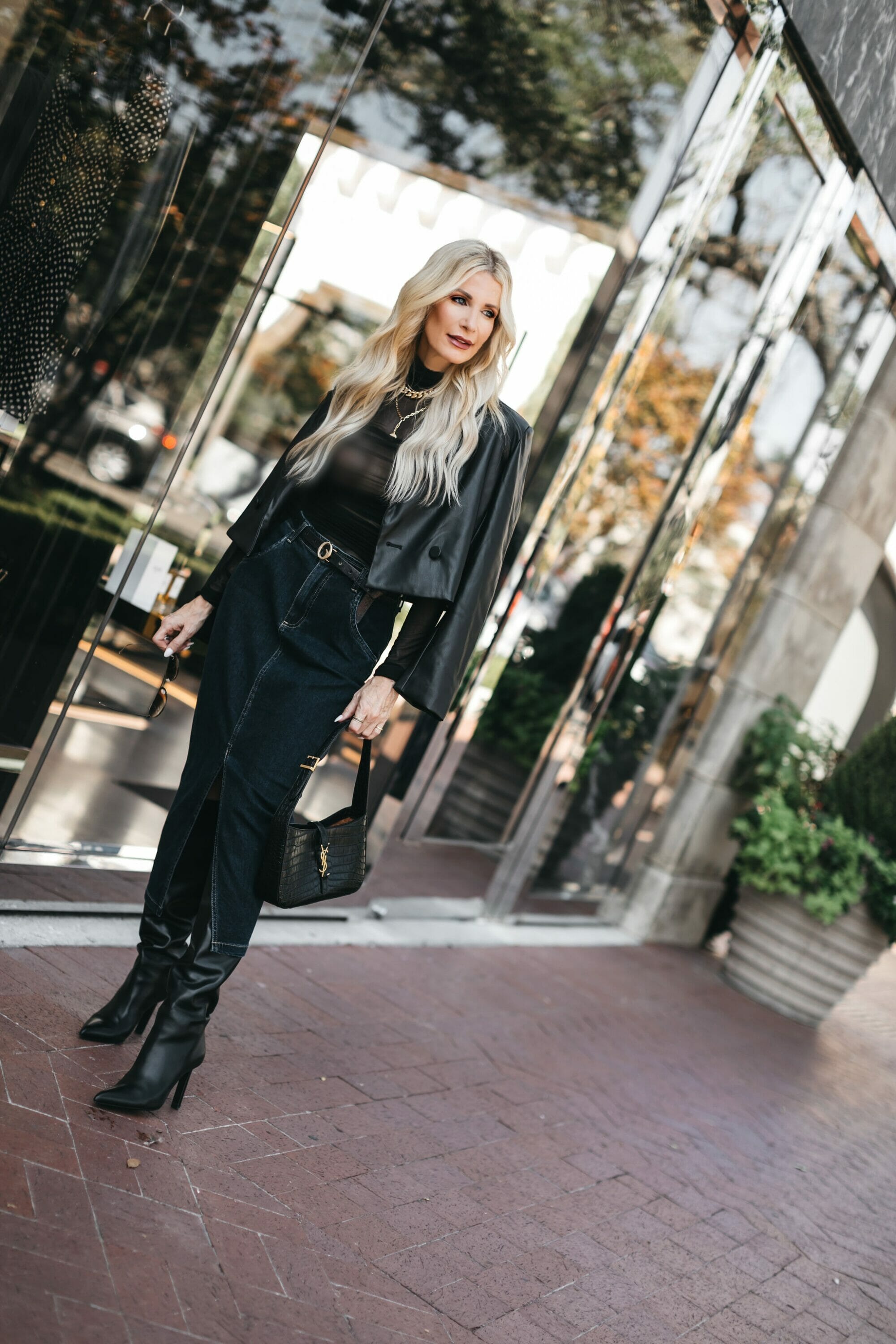 Dallas fashion stylist for women over 40 wearing dark wash denim midi skirt with a sheer bodysuit as one of the most wearable fall fashion trends.