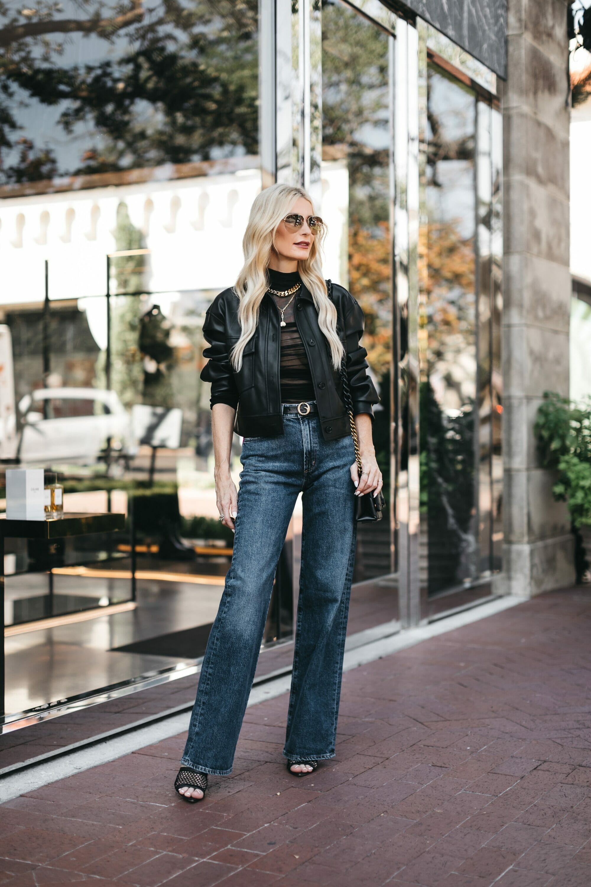 Over 40 fashion blogger from Dallas wearing cropped leather jacket and dark wash jeans as 3 key pieces of her fall capsule wardrobe 2023.
