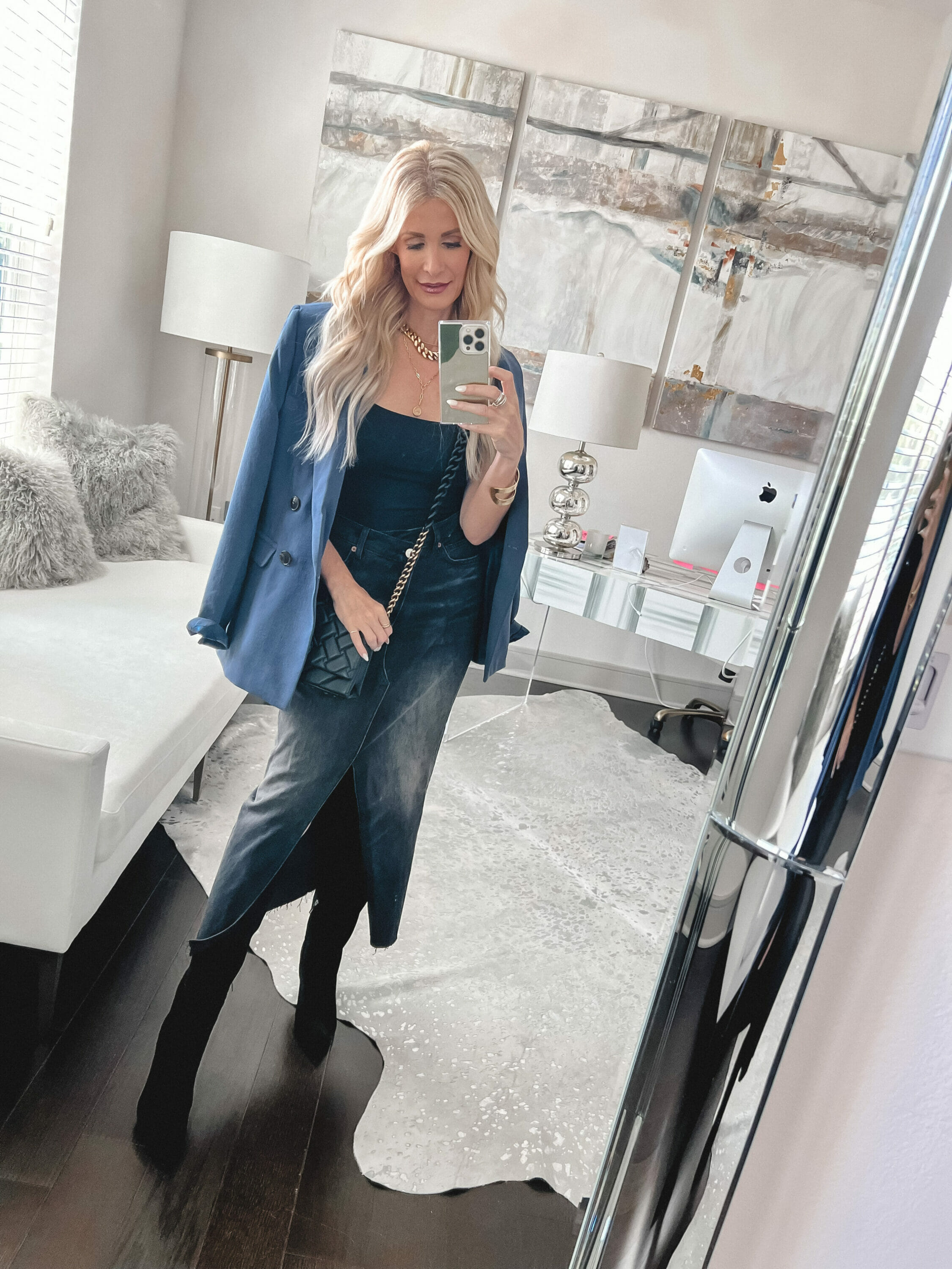 Dallas over 40 fashion influencer wearing Marc Fisher suede knee-high boots with a blue blazer and black denim midi skirt as one way to to style the hottest boot trend.