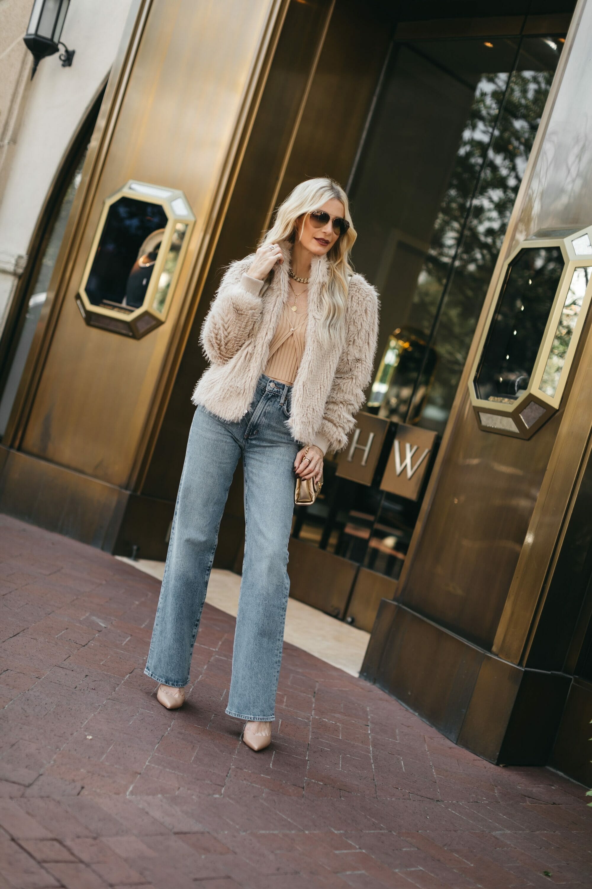 Over 40 fashion stylist from Dallas Texas wearing a faux fur jacket which is a key piece from her fall capsule wardrobe 2023.