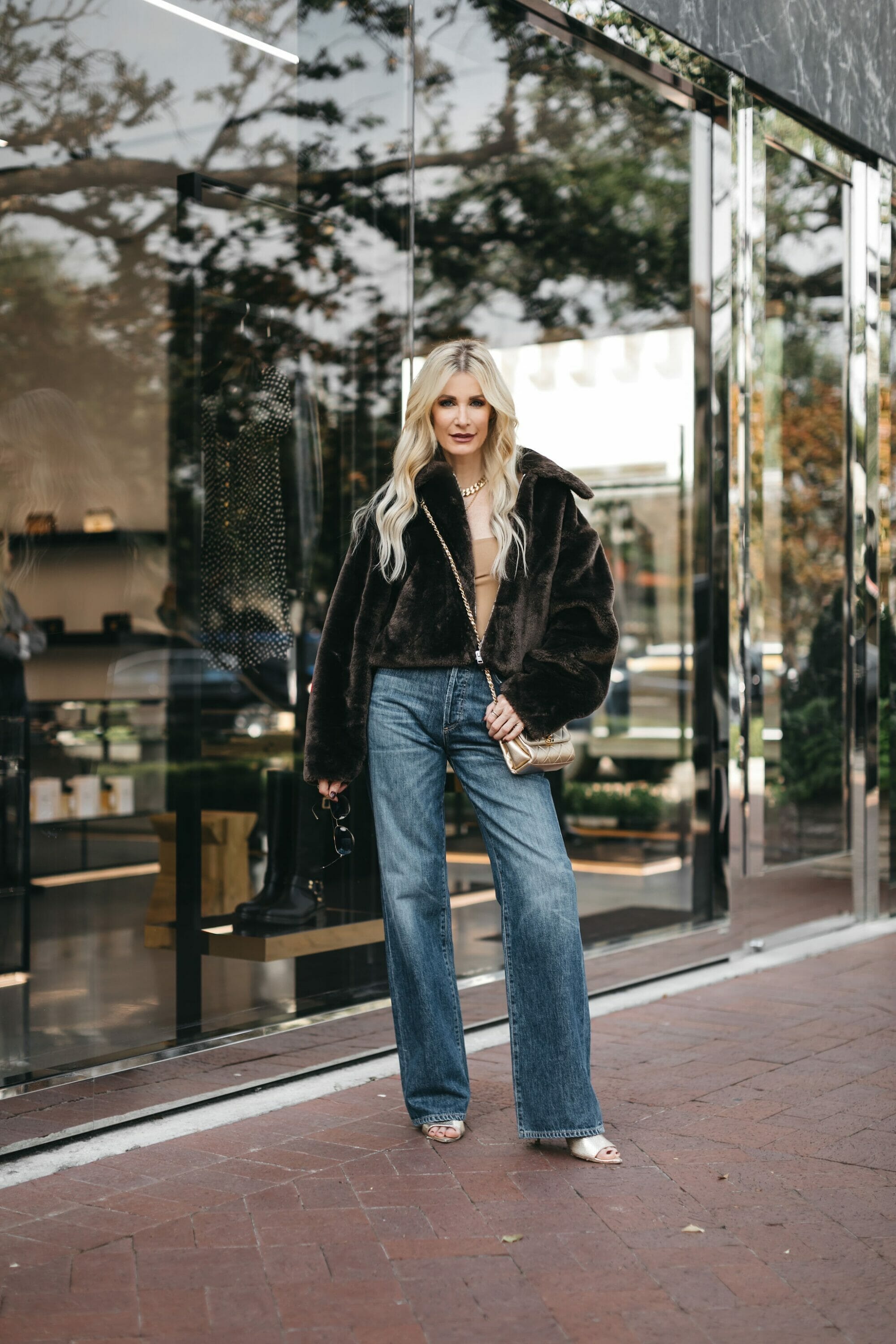 Over 40 Dallas fashion bloggers wearing a faux leather coat over a neutral base layer as one of 3 easy fall looks for women over 40.