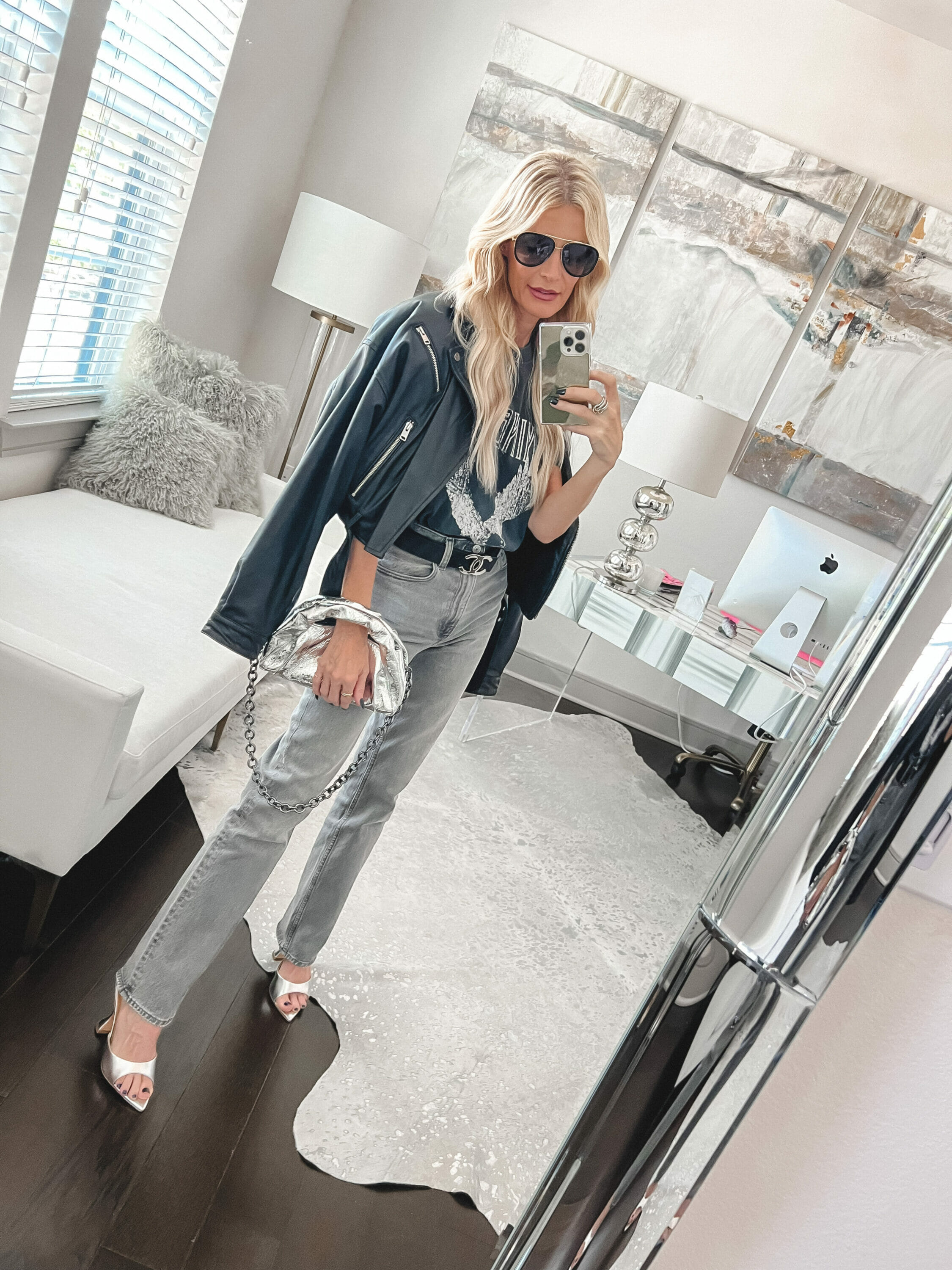 Woman over 40 wearing a graphic tee with grey jeans and silver accessories as one of the best sellers of September 2023.