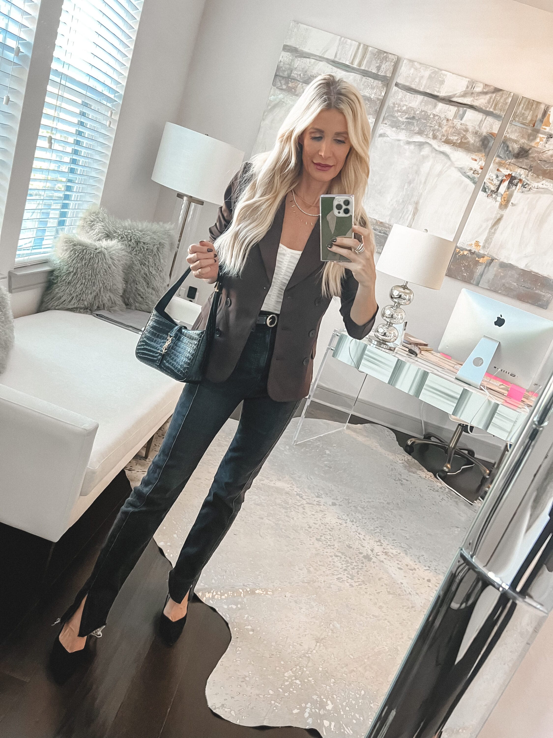 Over 40 fashion influencer showcasing the Best Black Friday Sales of 2023 in a brown blazer and black 90's jeans.