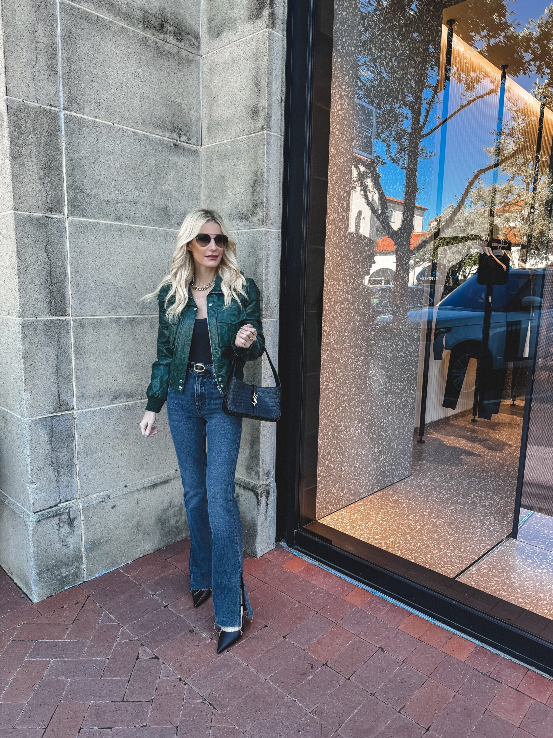 Dallas fashion blogger over 40 wearing non-distressed denim with a olive green leather jacket.