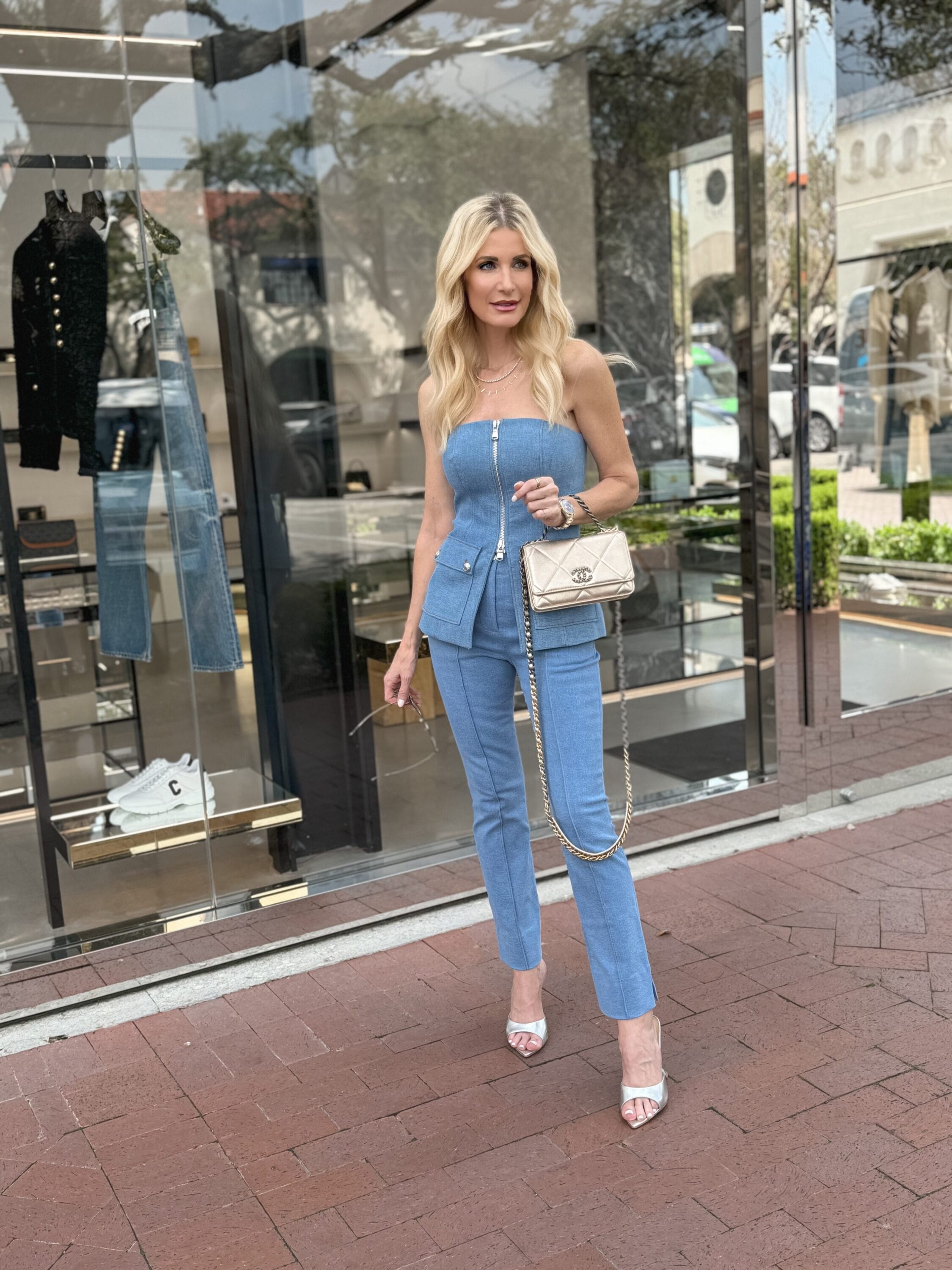 Over 40 fashion influencer wearing a denim suit from veronica beard with metallic accents in a video about her personal journey with toxic relationships.