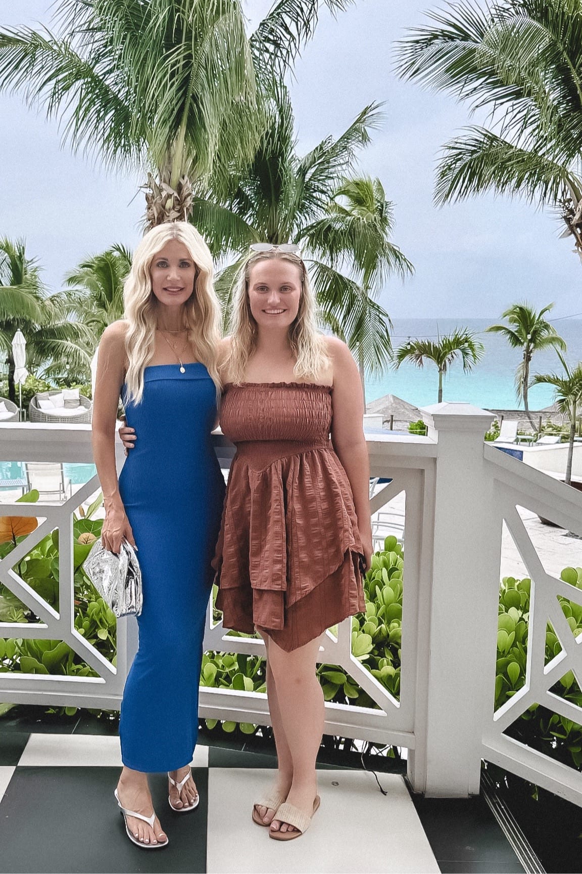 Dallas fashion influencer for women over 40 posing with her daughter while wearing beach vacation outfits.
