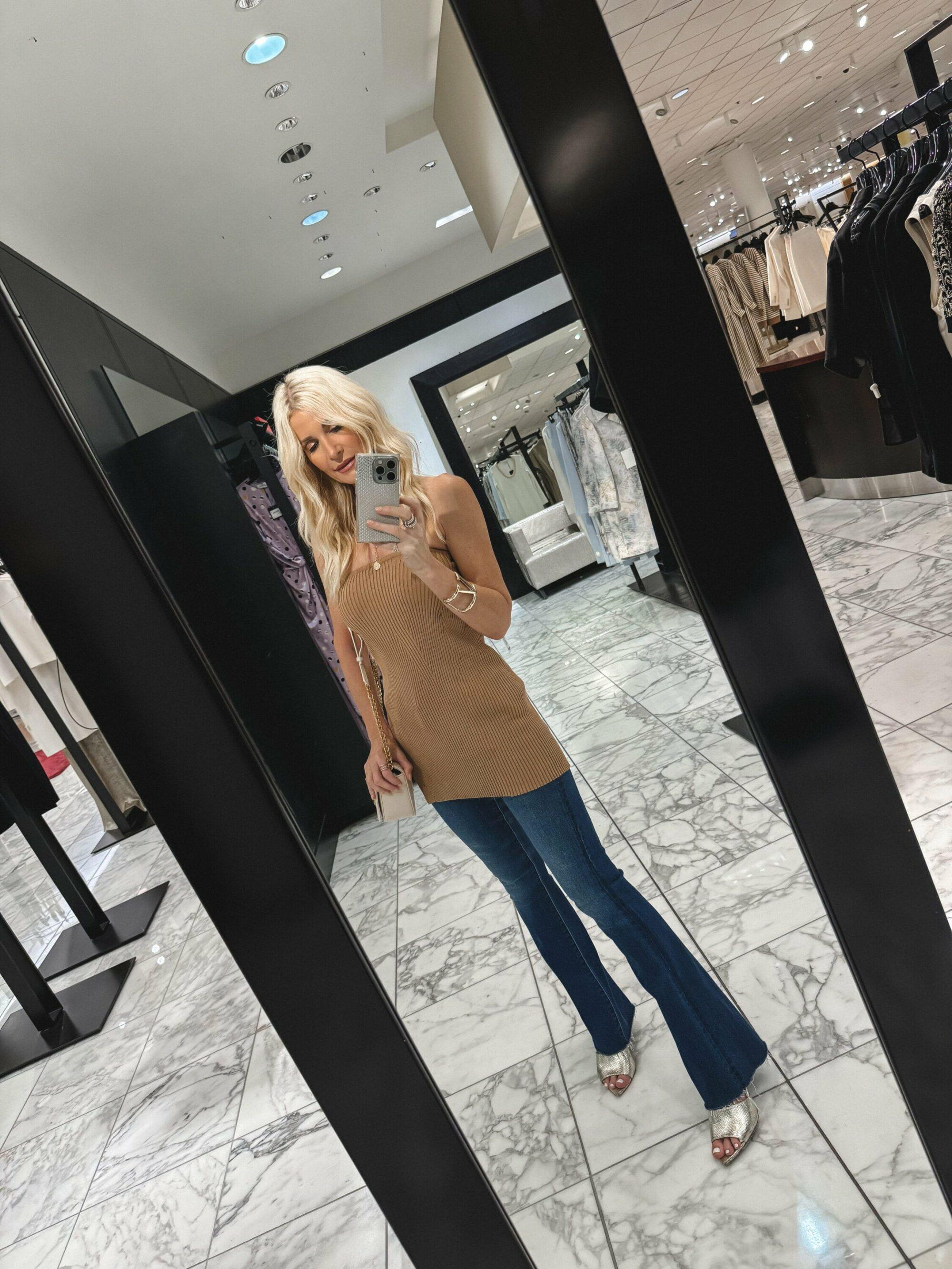 Dallas fashion influencer for women over 40 wearing a square neck ribbed top with flare jeans and gold heels.