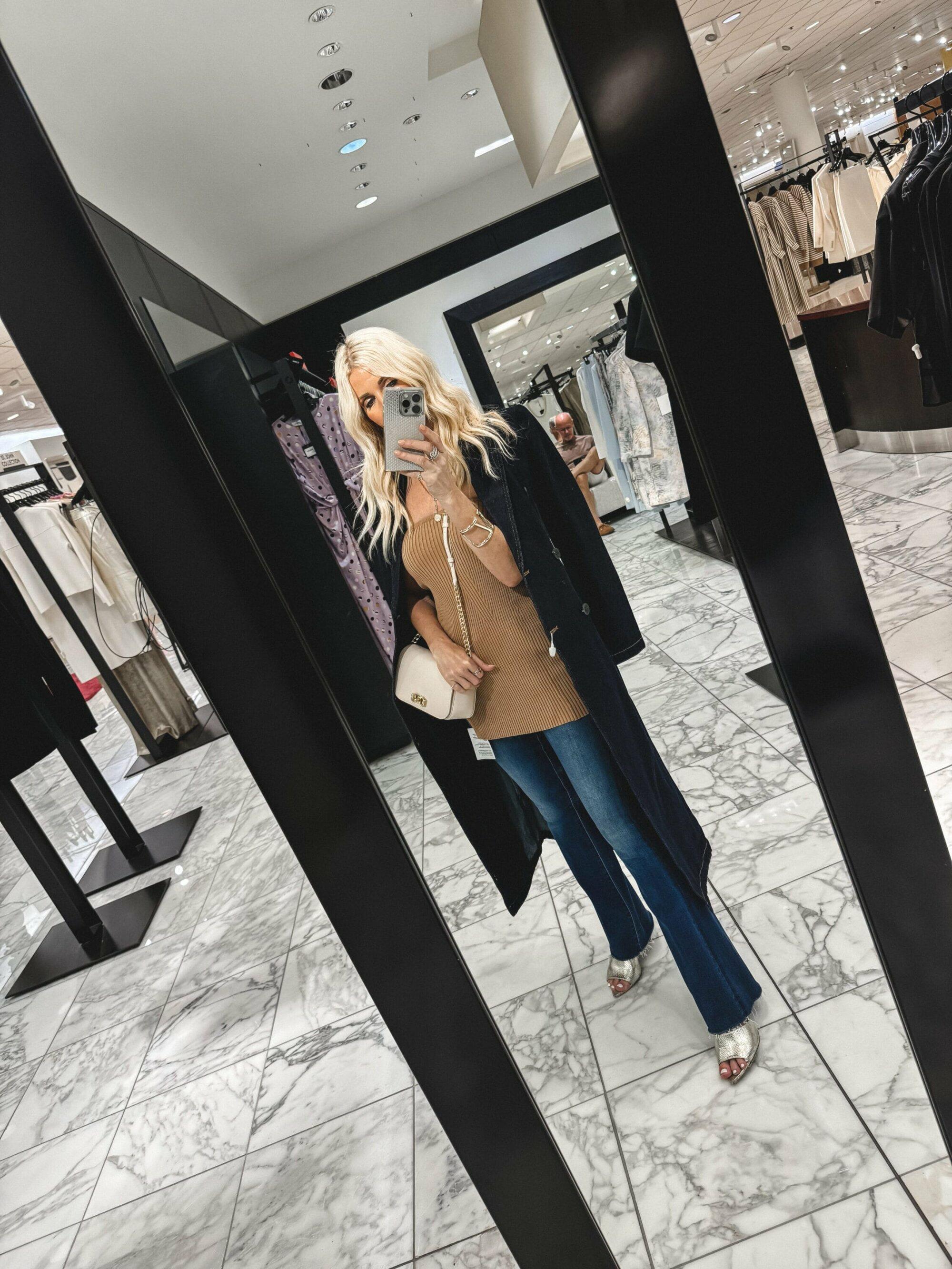 Over 40 Dallas woman wearing a strapless top with blue flare jeans and gold heels as one of the top 10 under $100 finds from the Nordstrom Anniversary Sale.