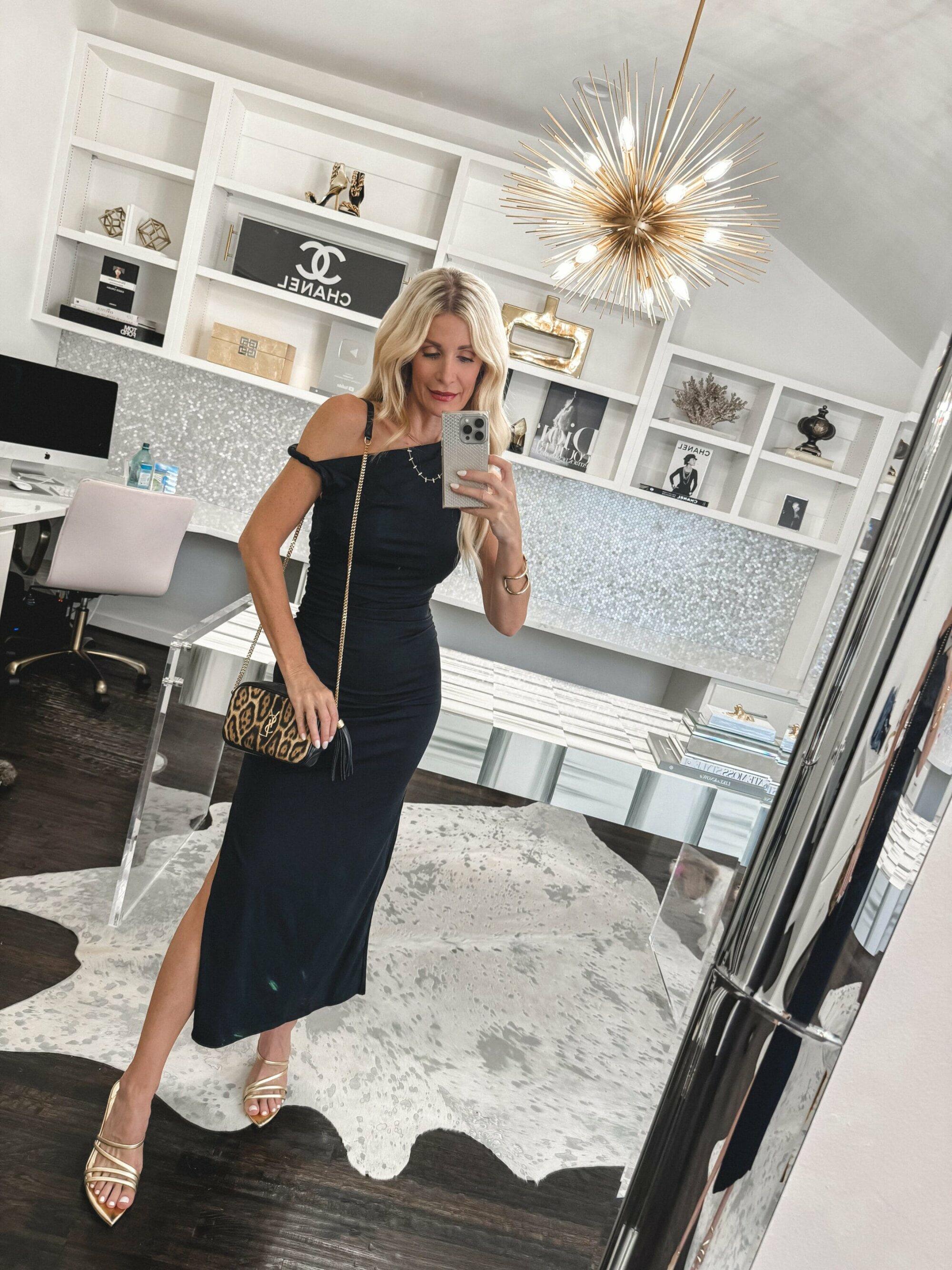 Over 40 fashion blogger wearing a black off the shoulder dress from Abercrombie & Fitch with gold heels and a leopard handbag.