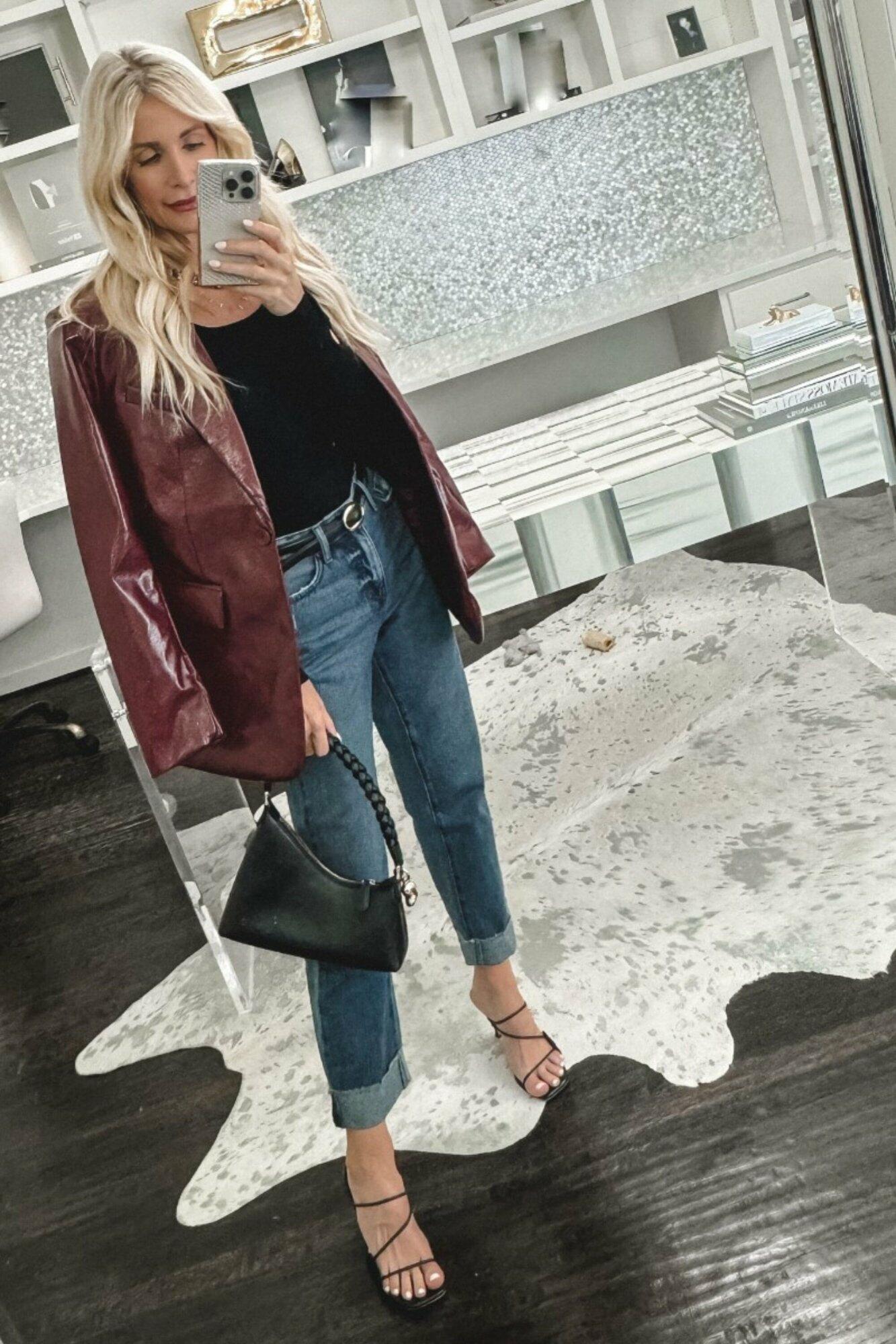 Dallas woman over 40 wearing a burgundy blazer with a black long-sleeve and cuffed jeans as 3 examples of under $50 pieces for fall.