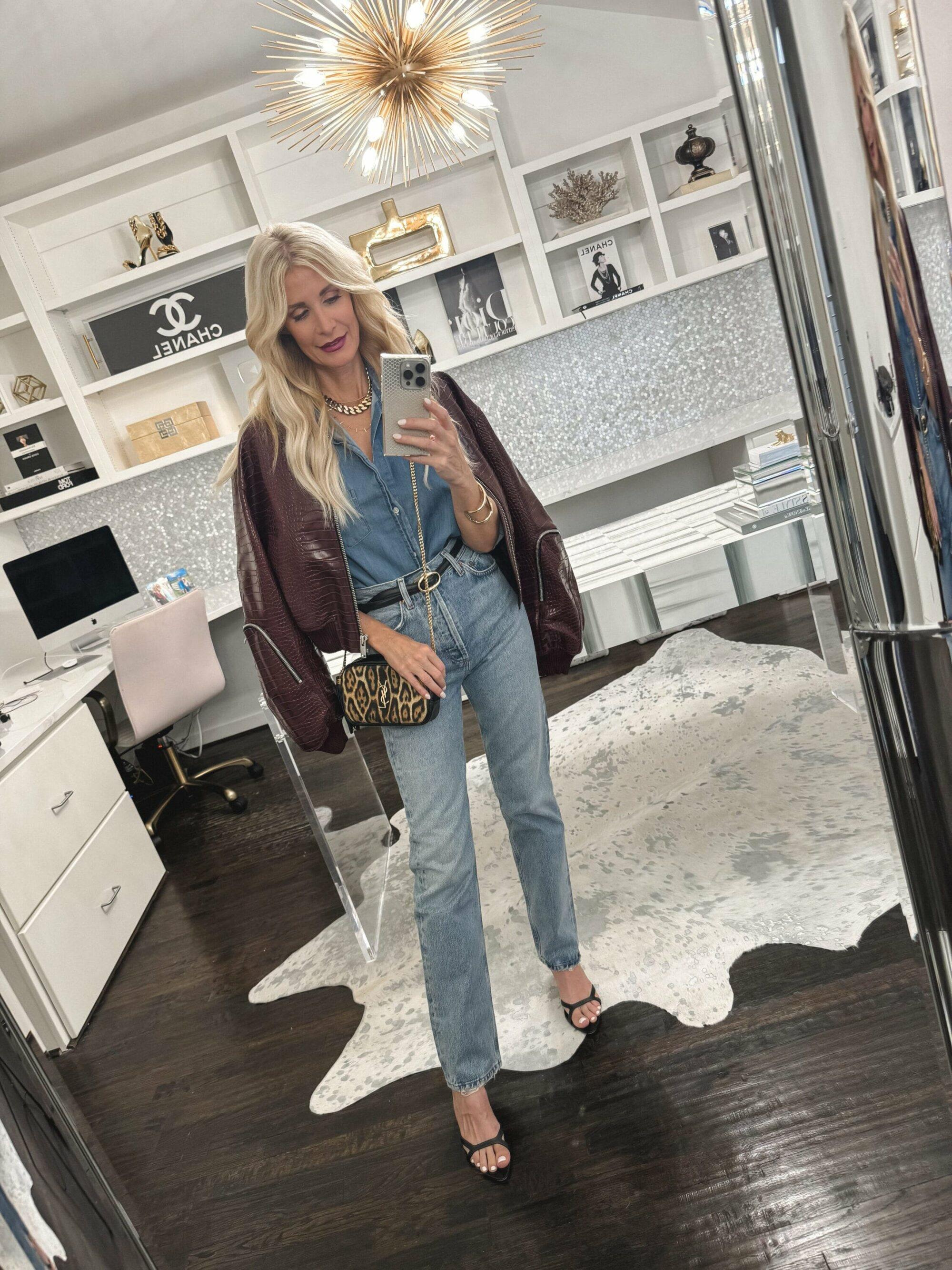 Dallas woman over 40 wearing double denim with a burgundy faux leather jacket.