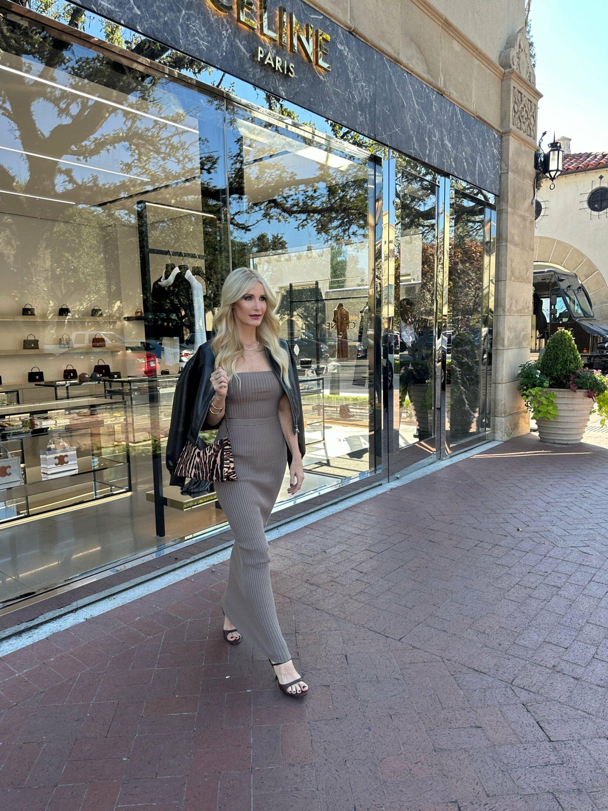 Dallas fashion blogger wearing a matching taupe skirt and top with a dark brown leather bomber jacket and kitten heels with an animal print handbag.
