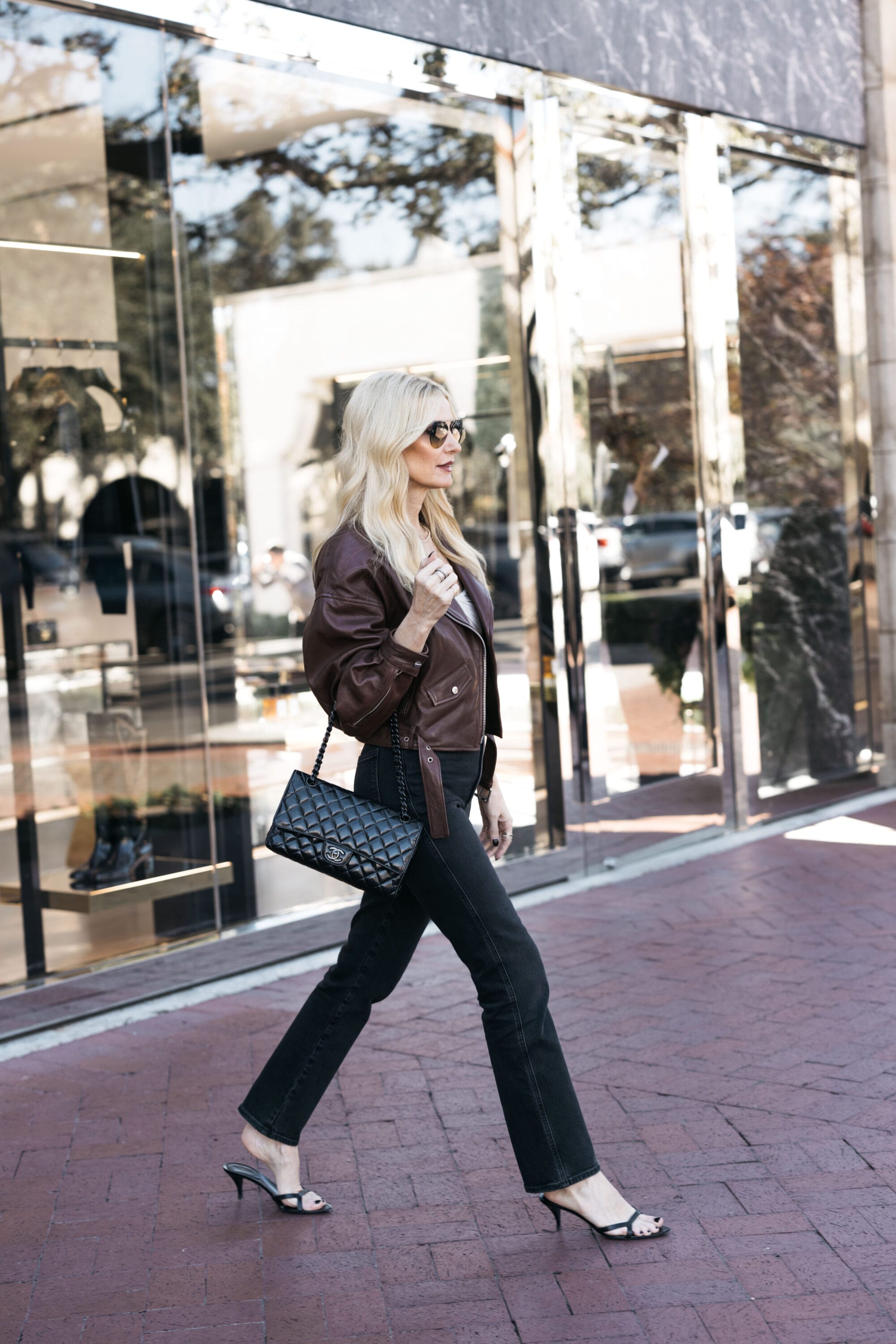Dallas fashion blogger wearing a brown leather jacket with a pair of black high waisted denim and kitten heels as one of 5 options for what to wear on thanksgiving.