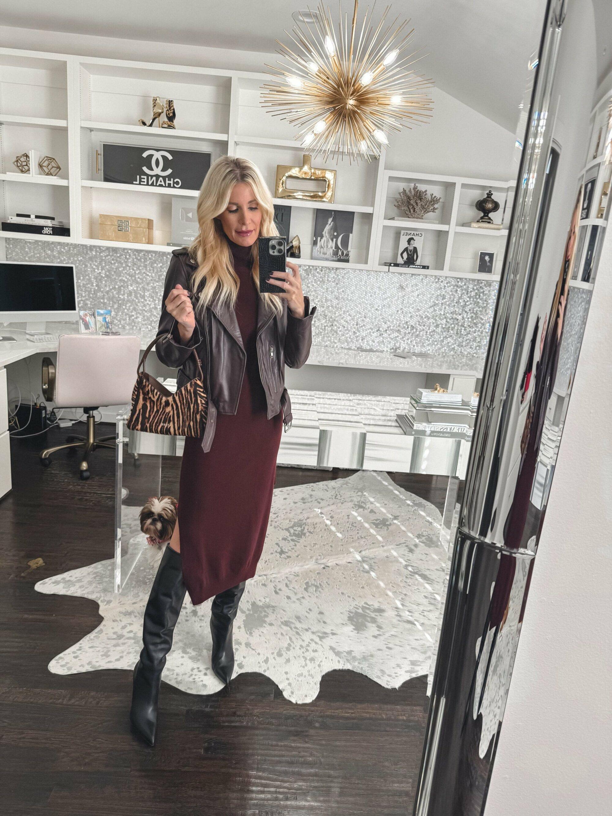 Dallas fashion influencer for women over 40 wearing a burgundy cashmere slip dress with a matching leather jacket and knee high boots.