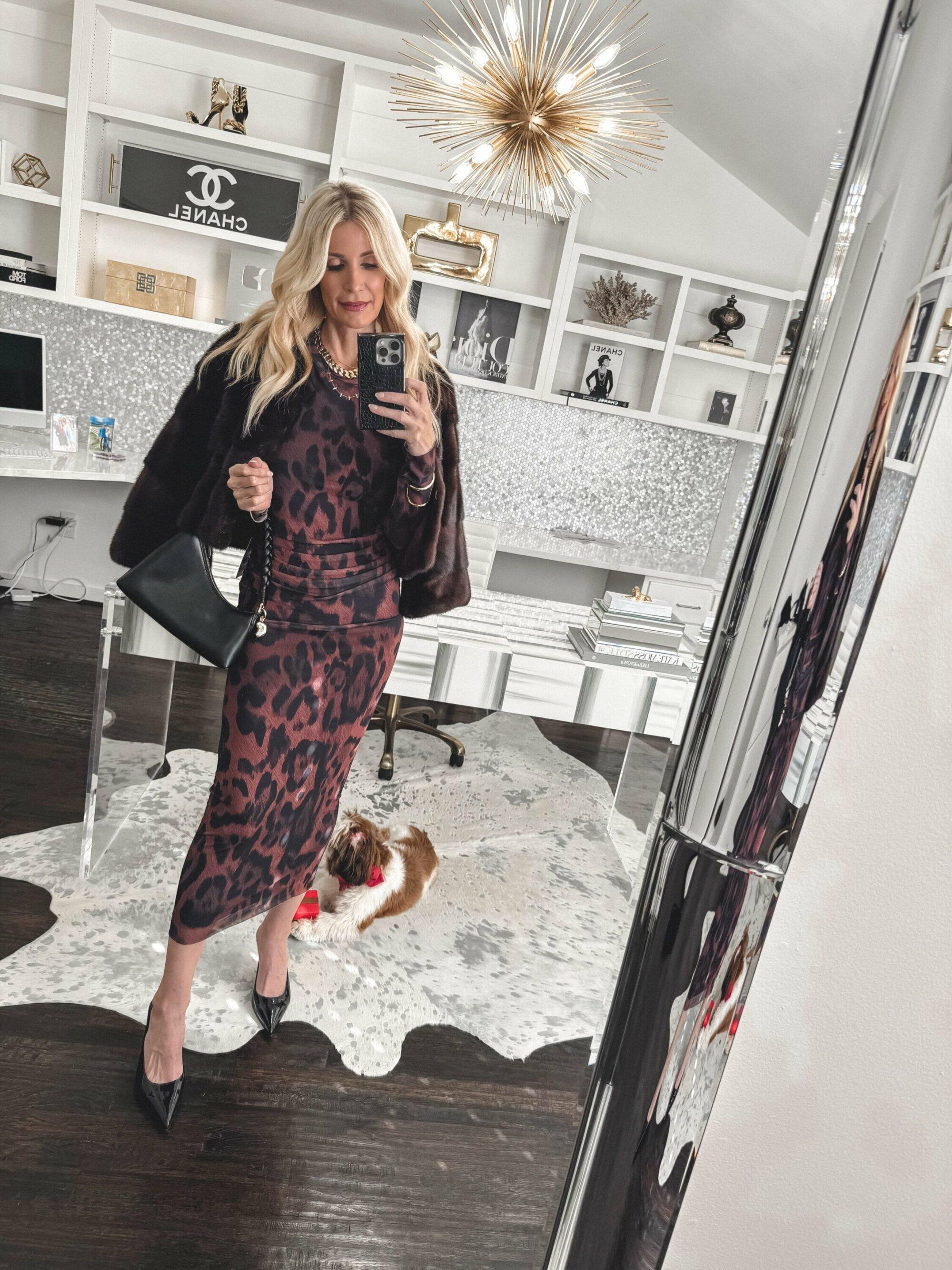 Dallas fashion blogger over 40 wearing a Leopard midi dress with pointed toe heels and a faux fur jacket as one of 5 Transitional Dresses.