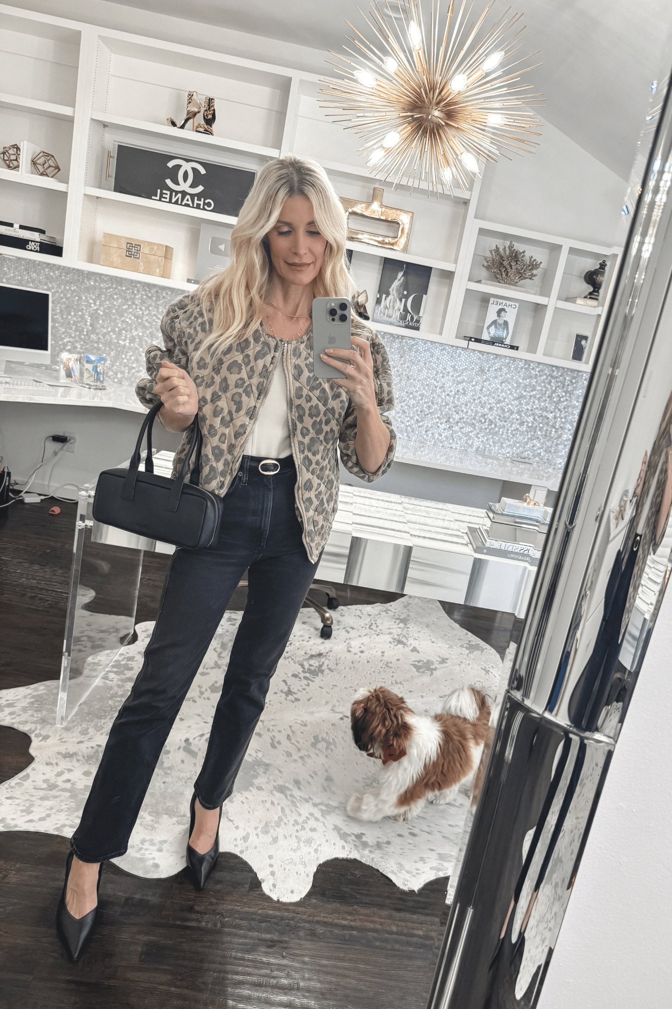 Over 40 fashion stylist wearing a leopard jacket and black Agolde jeans which are one of 5 February Best Sellers for Stylish Spring Outfits.