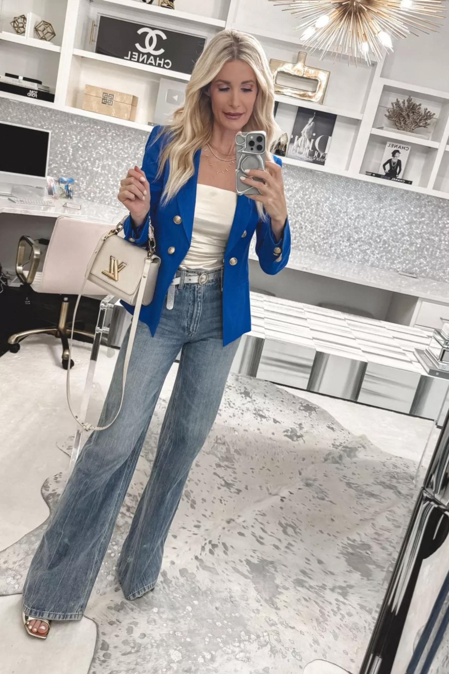 Over 40 fashion icon sharing overly distressed denim as one of 5 Fashion Items to Ditch if you're Over 40 and wearing wide leg jeans instead.