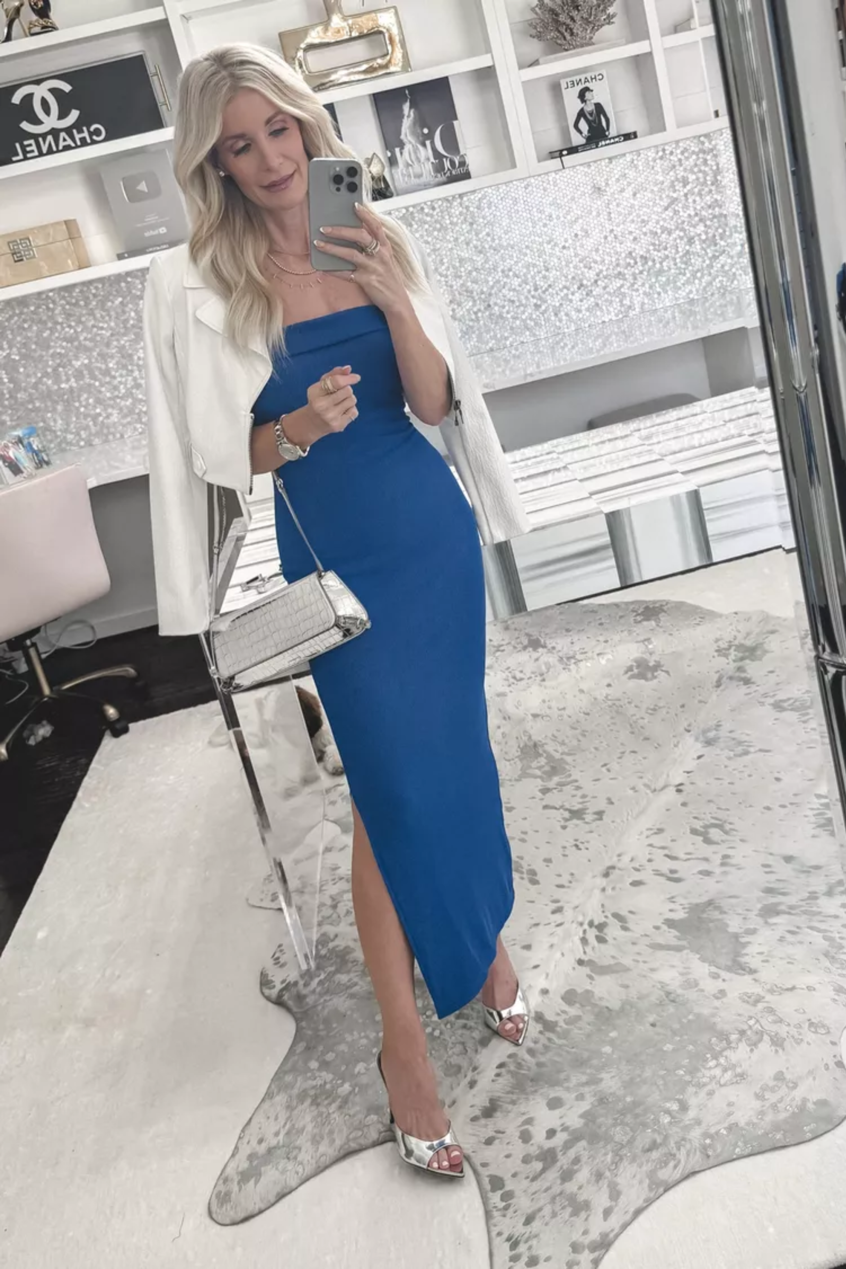 Over 40 fashion stylist from Dallas wearing a blue strapless midi dress with a white denim jacket.