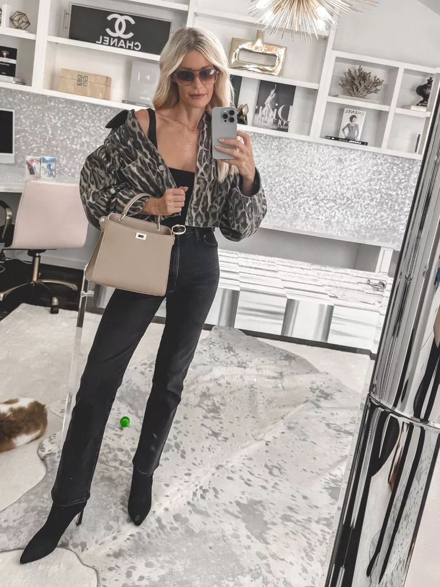 Dallas fashion blogger wearing a pair of straight leg jeans from Agolde with a animal print jacket and sock booties as one of the Top 5 Fall Denim Trends 2025.