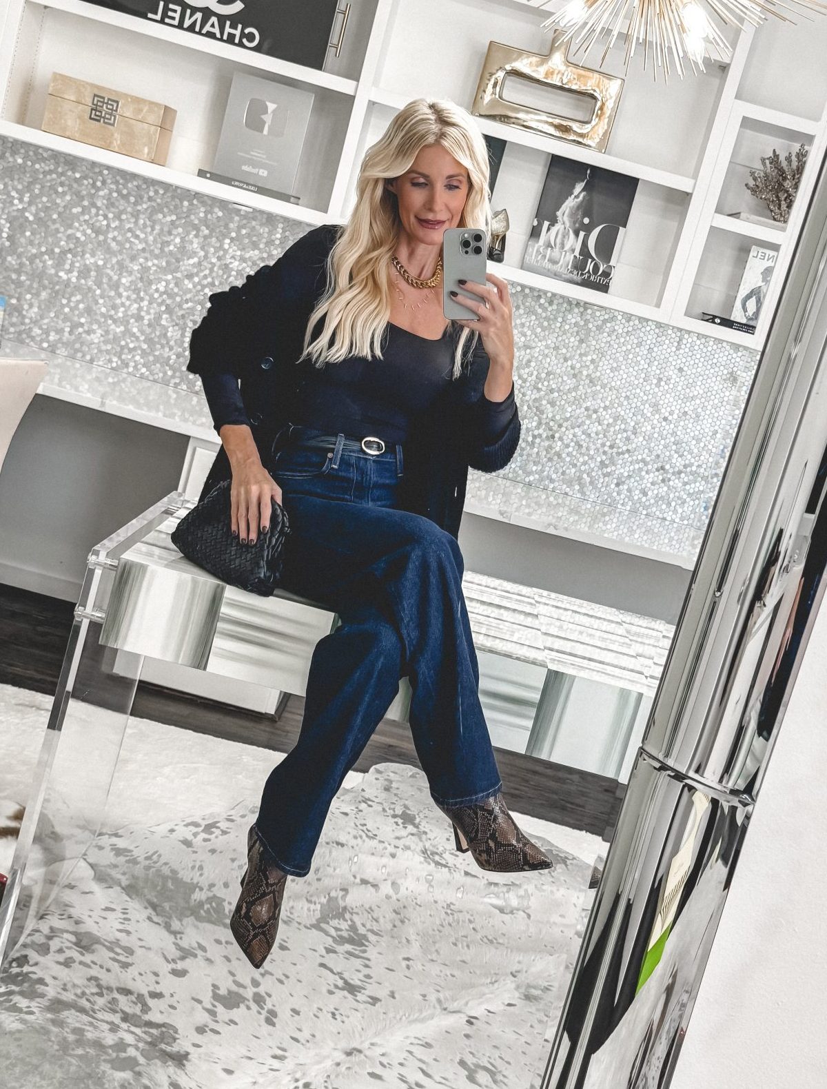 Dallas fashion blogger wearing snake skin booties with dark wash jeans and a cardigan.