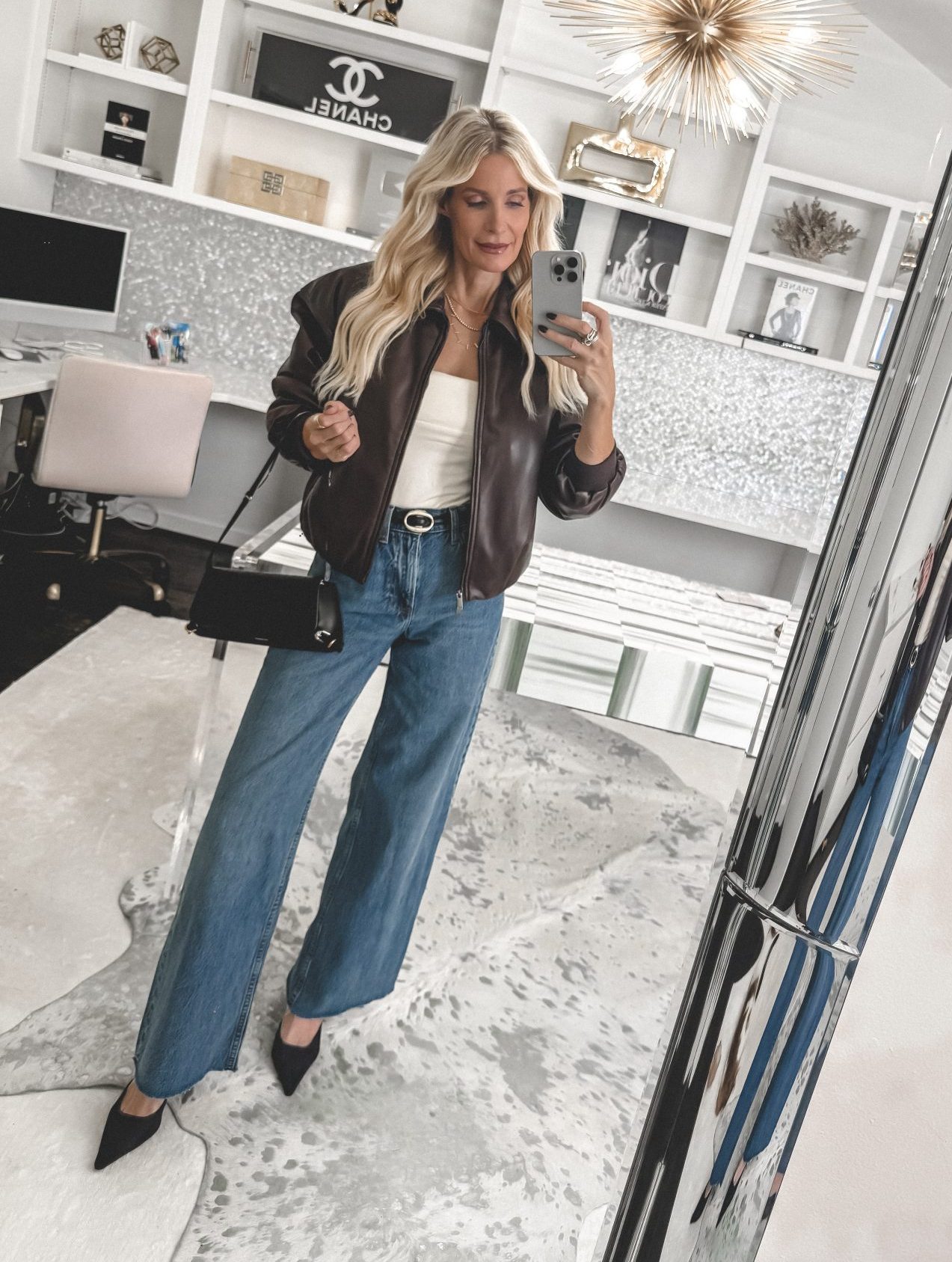 Over 40 Dallas fashion influencer wearing a brown faux leather jacket with a cropped silhouette that helps define your waist.