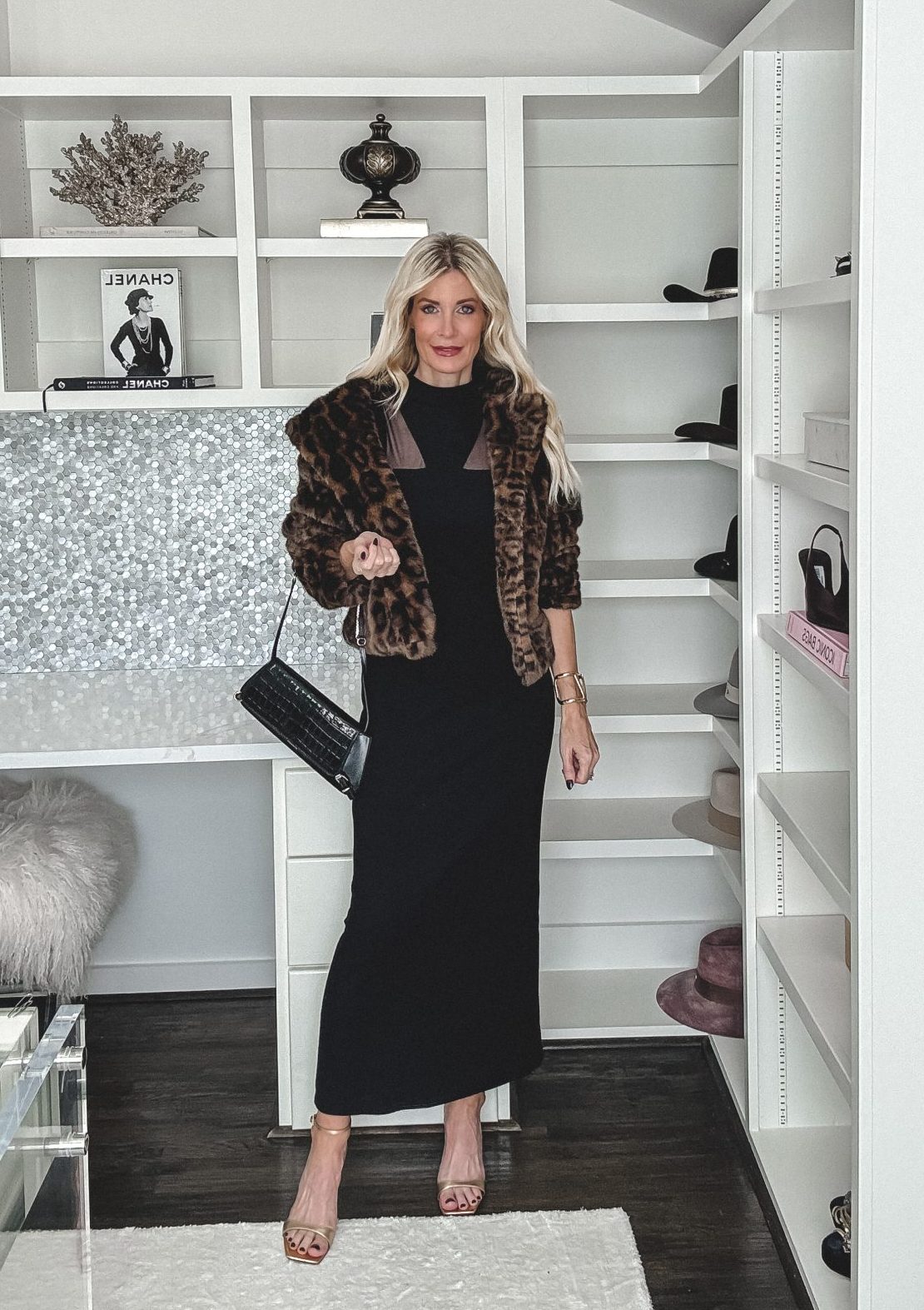 Over 40 Dallas fashion influencer wearing a LDB and a faux fur leopard jacket with metallic heels.