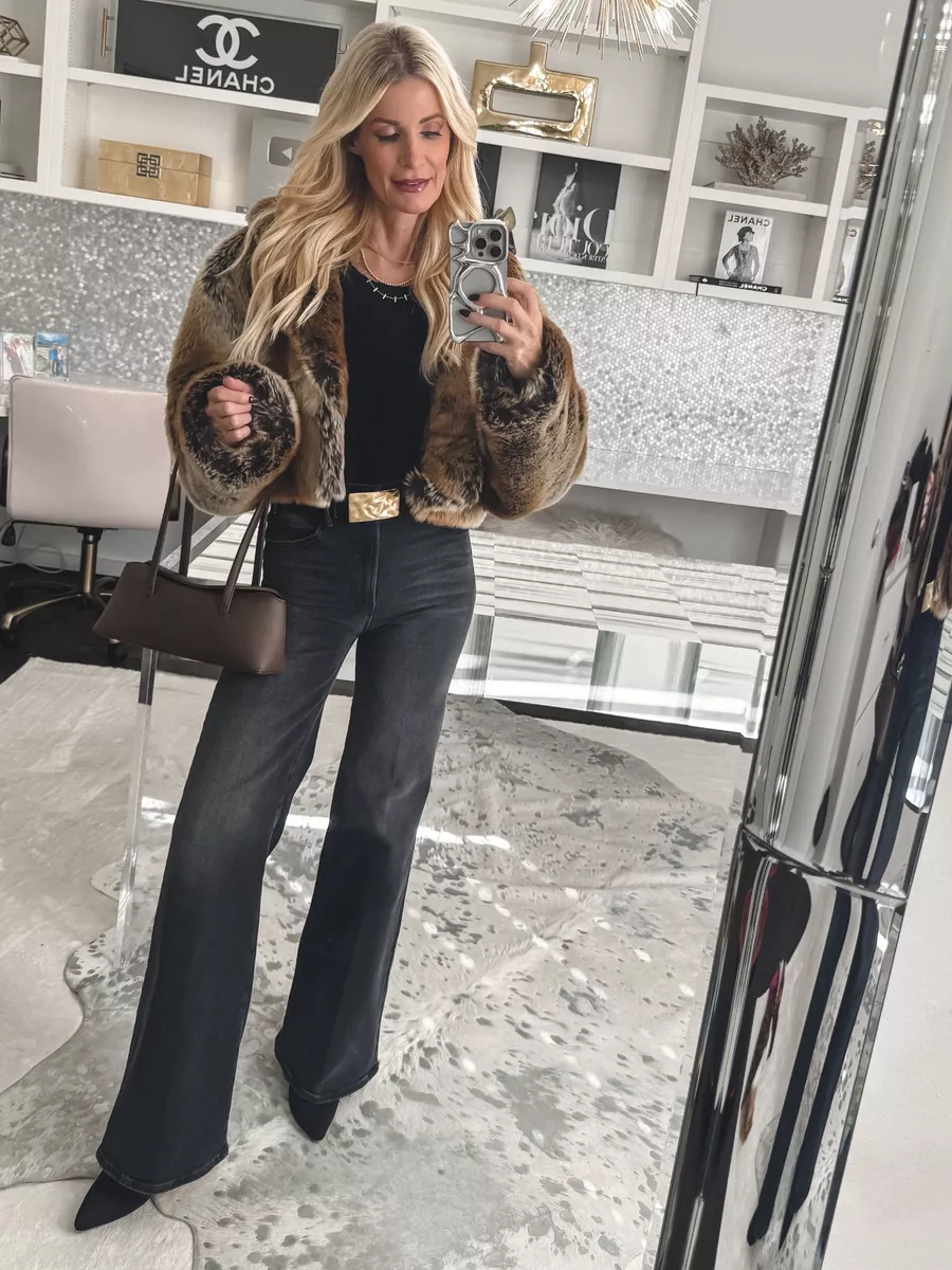 Over 40 fashion influencer wearing wide leg faded black wash jeans as an alternative to exaggerated barrel jeans which is one of 5 Denim Trends Out of Style in 2026.