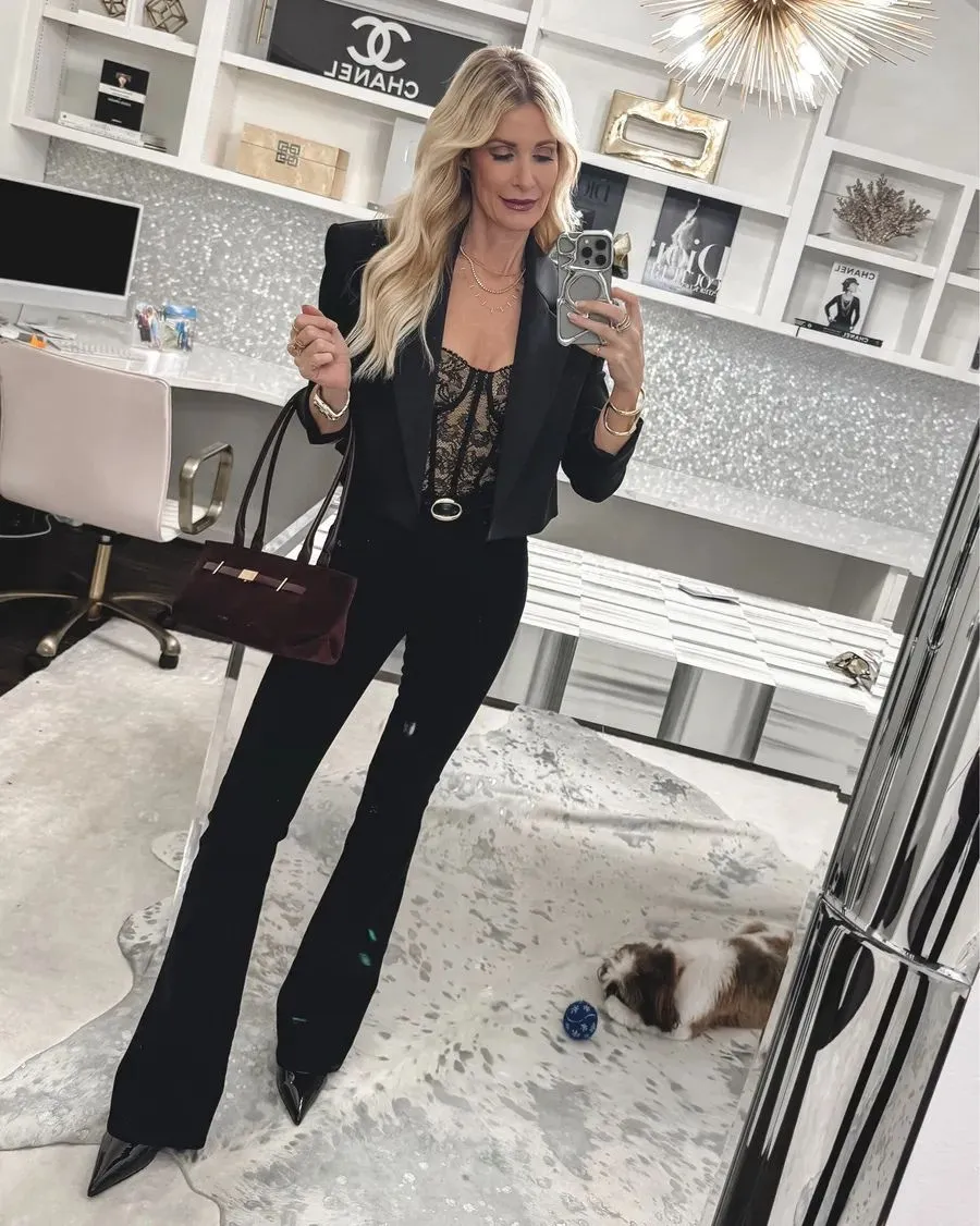 Over 40 fashion stylist from Dallas wearing Veronica Beard flare jeans with a black blazer and lace top.