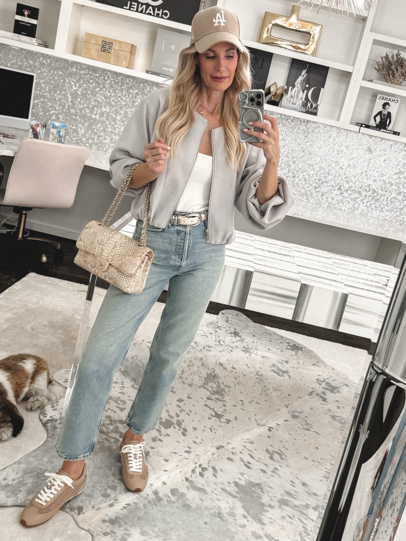 Dallas fashion over 40 wearing a bomber jacket, straight leg jeans and and slim sneakers as an alternative to one of 5 Sneakers and jeans outfit mistakes.