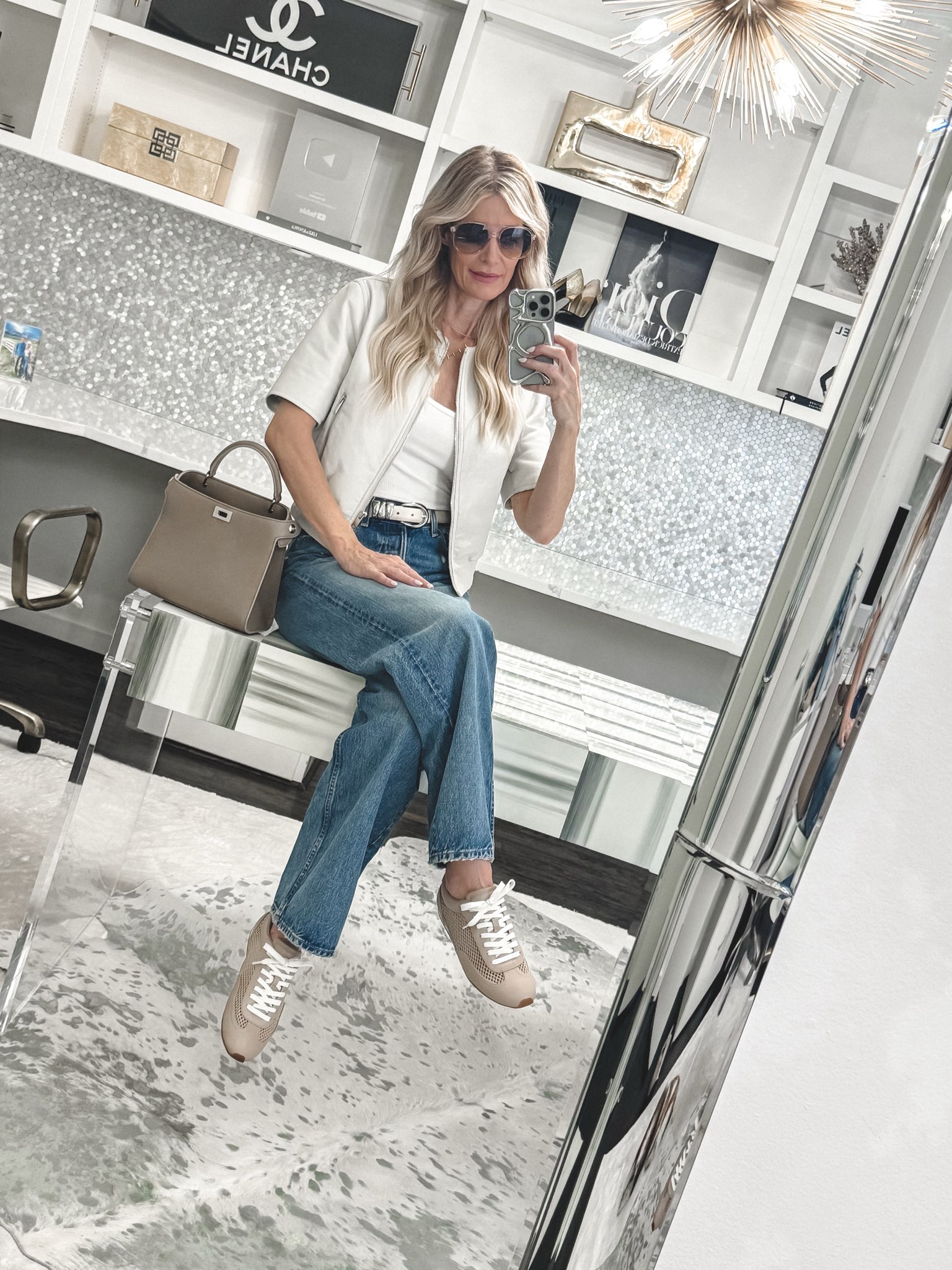 Fashion blogger over 40 wearing slim sneakers and wide leg jeans as a chic alternative to one of 5 Sneakers and jeans outfit mistakes.