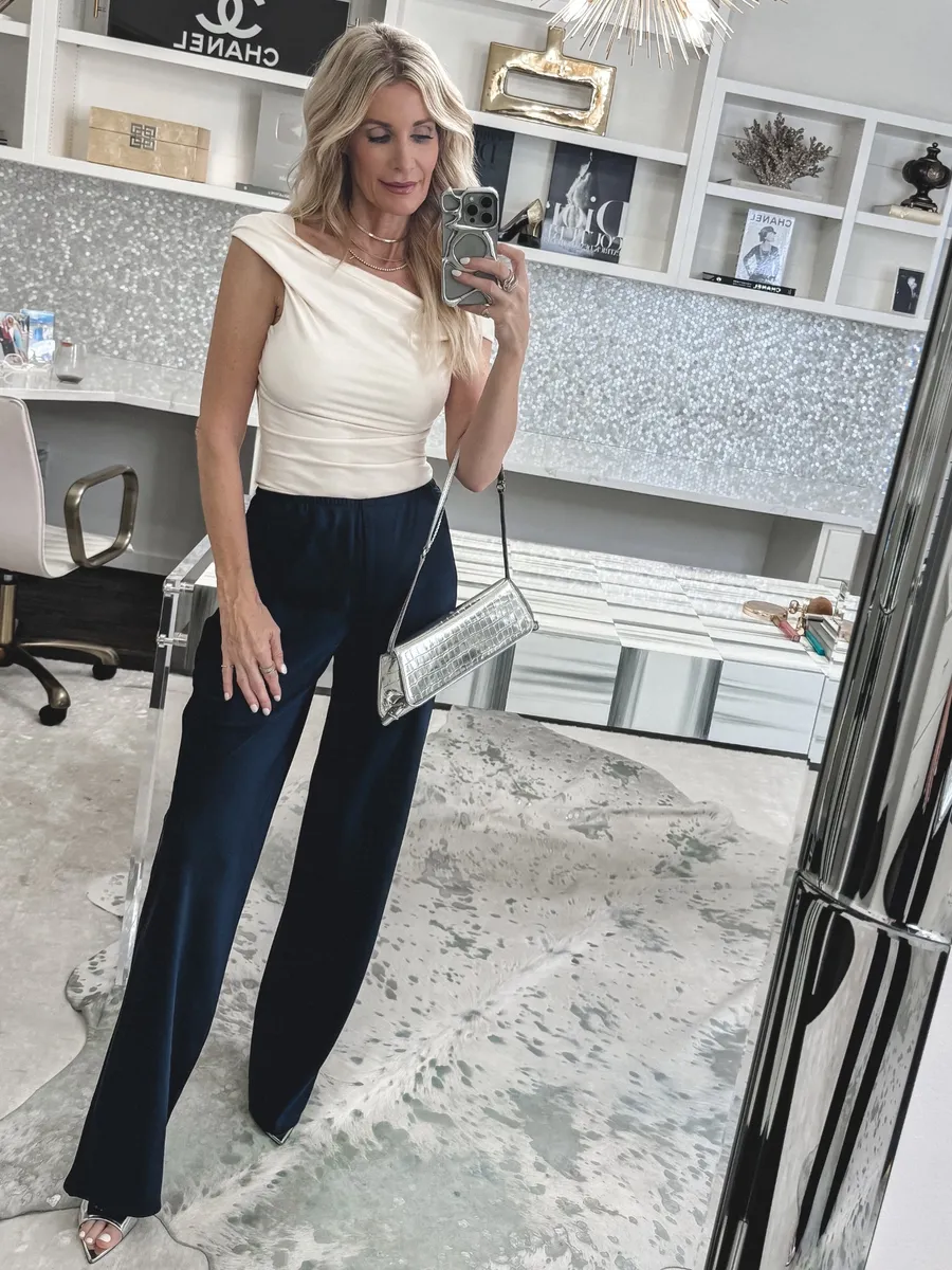 Fashion Stylist wearing a one shoulder summer top with satin pants.