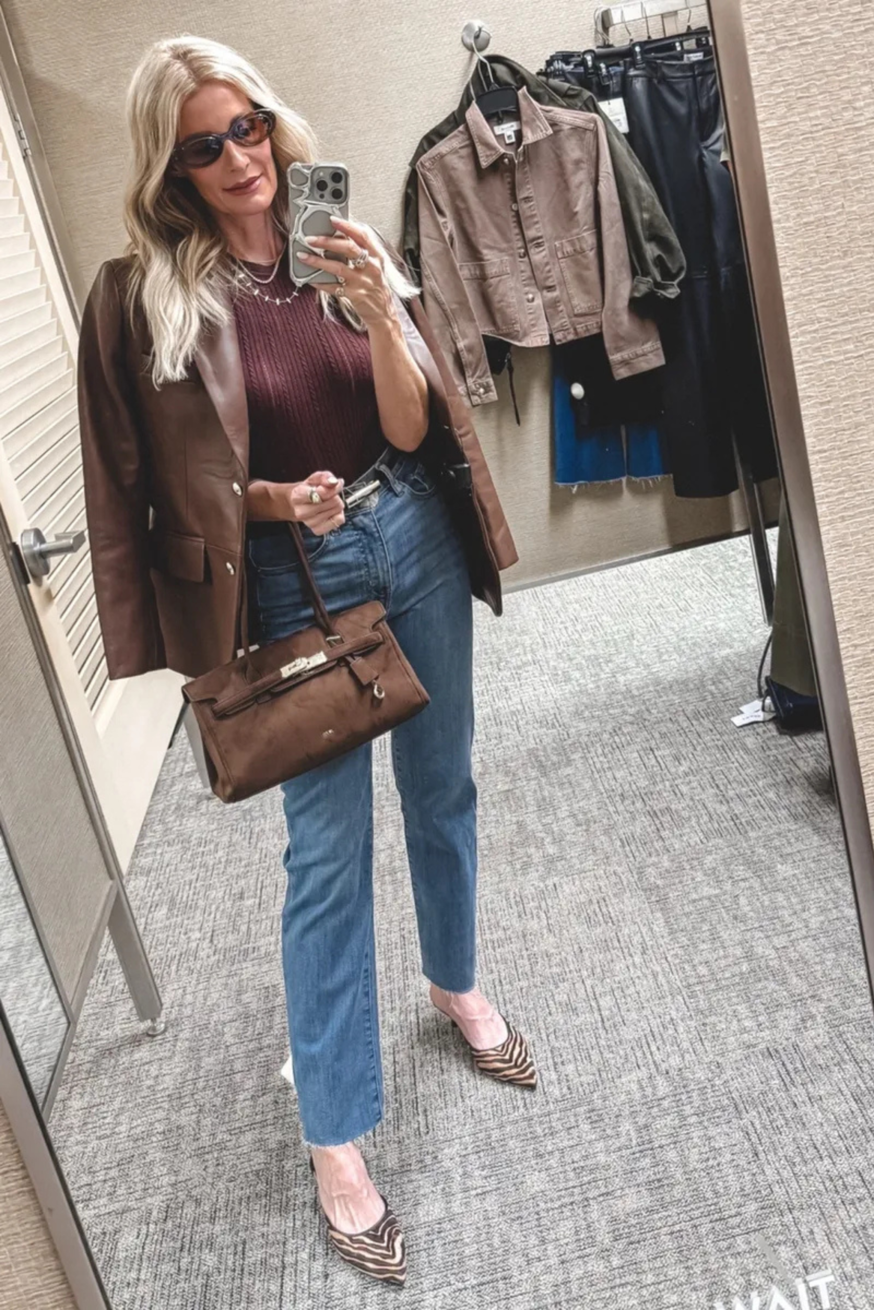 Fashion blogger wearing a sweater tank with brown leather blazer and zebra heels.