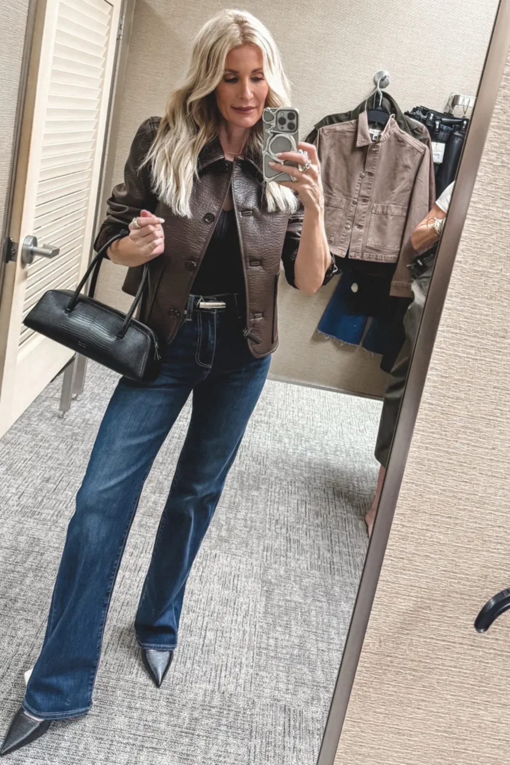 Dallas fashion blogger over 40 wearing a shearling lined leather jacket with flare jeans and black leather heels and a slim belt as one of Nordstrom Anniversary Sale Outfits.