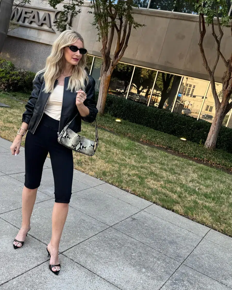 Dallas fashion blogger for women over 40 wearing a pair of black capris and black shoes with an ivory top and leather bomber jacket as a fix for common style mistakes.